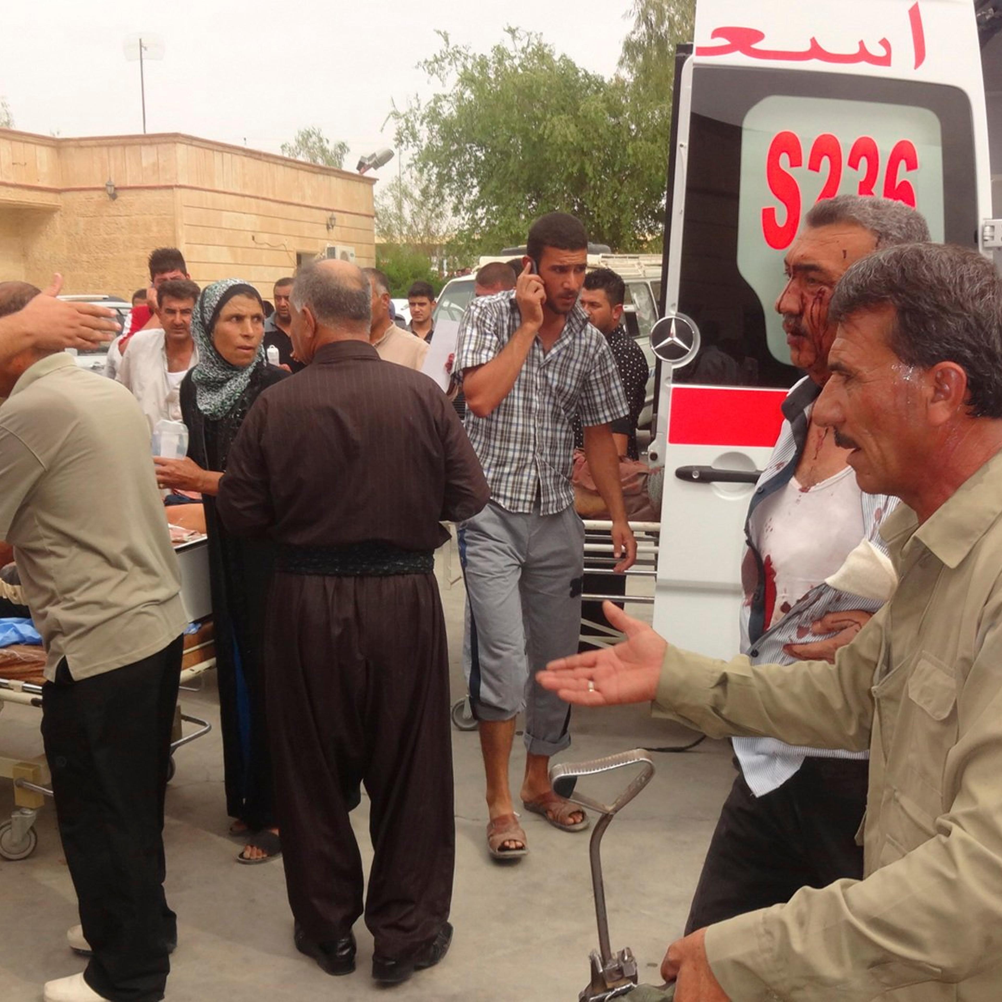 Men wounded by a car bomb in Qara Qubah are transported to a hospital in Kifri, Iraq on Oct. 12, 2014.