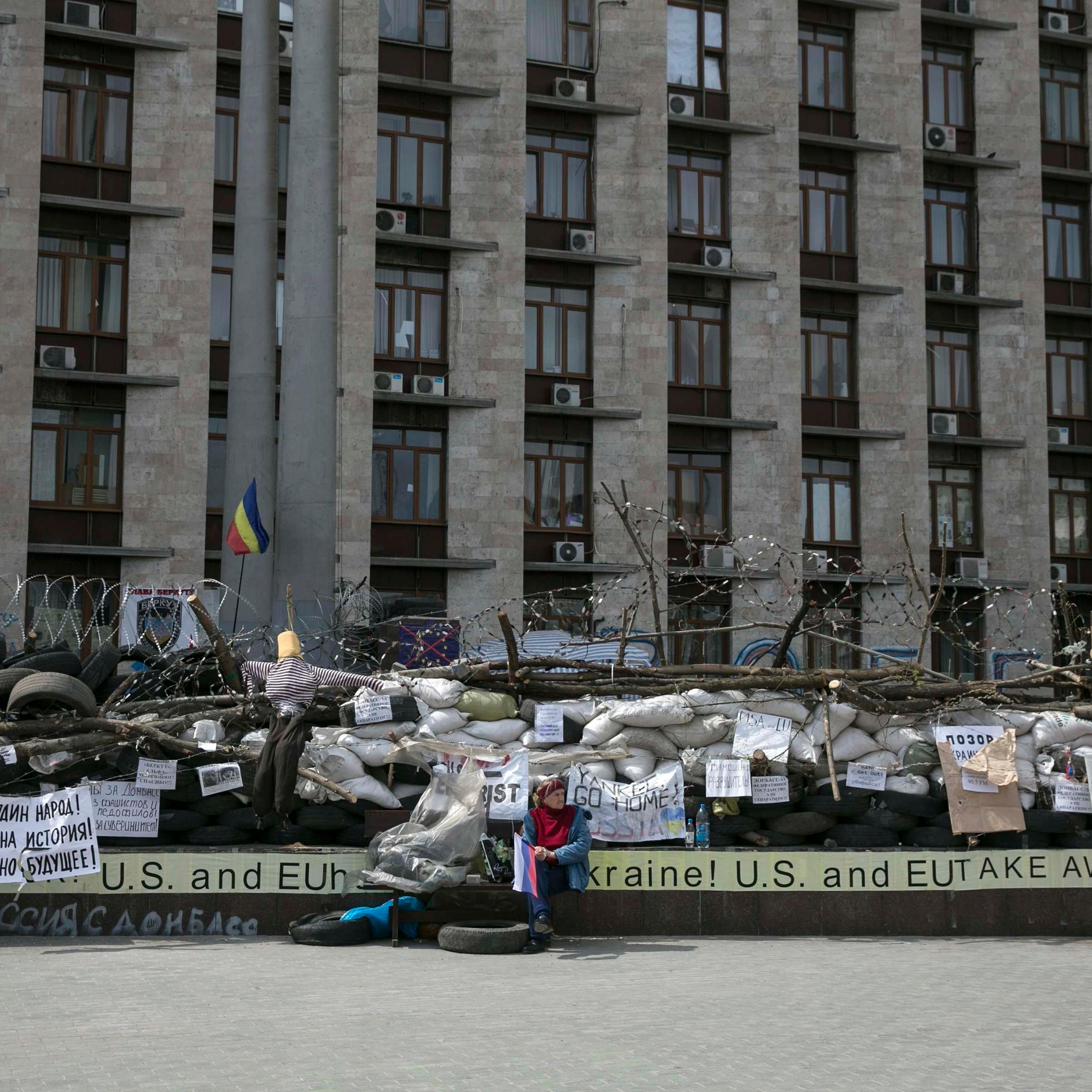 A pro-Russia woman holds a Russian flag outside a regional government building in Donetsk