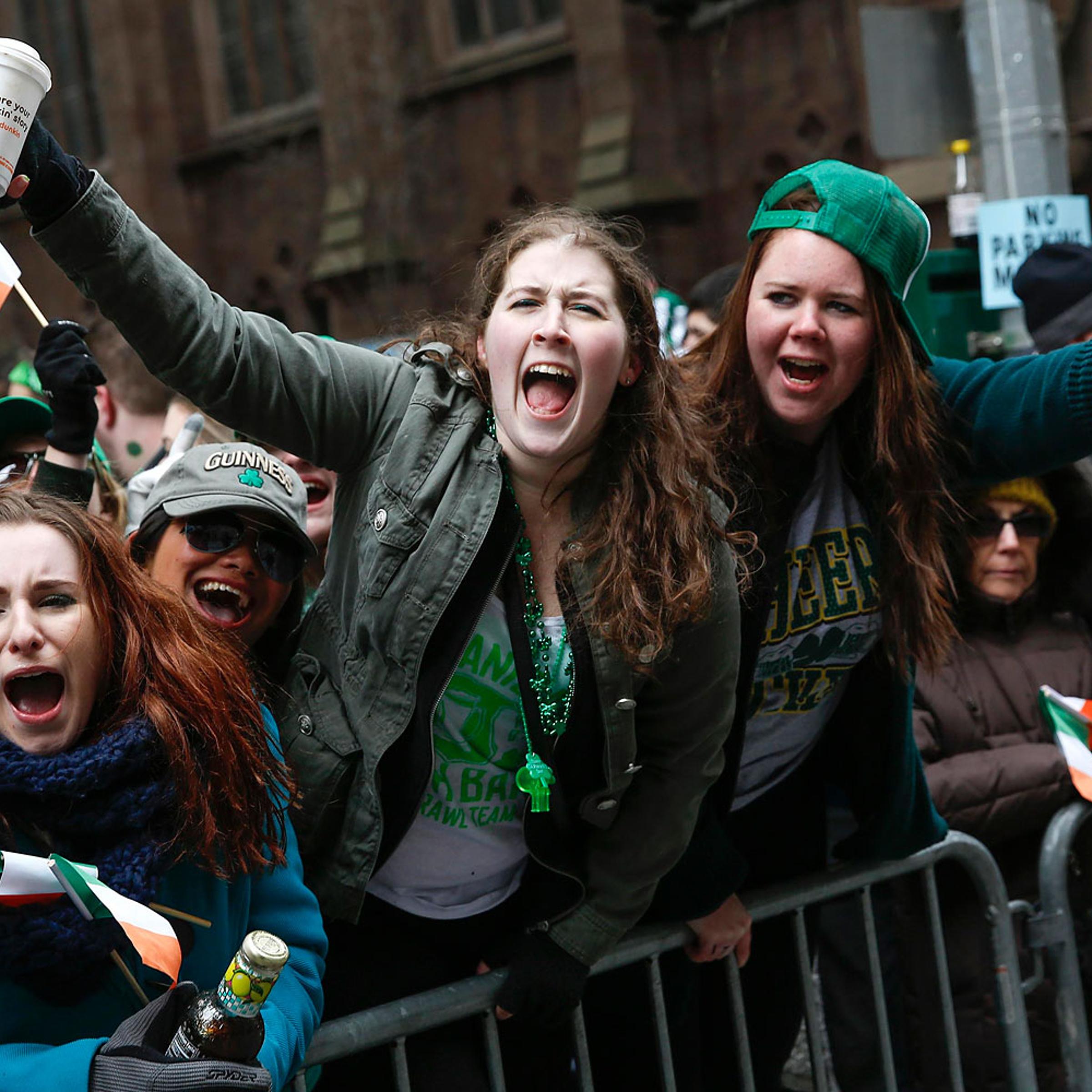 People cheer along 5th avenue during the St. Patrick's Day parade in New York, March 17, 2014.