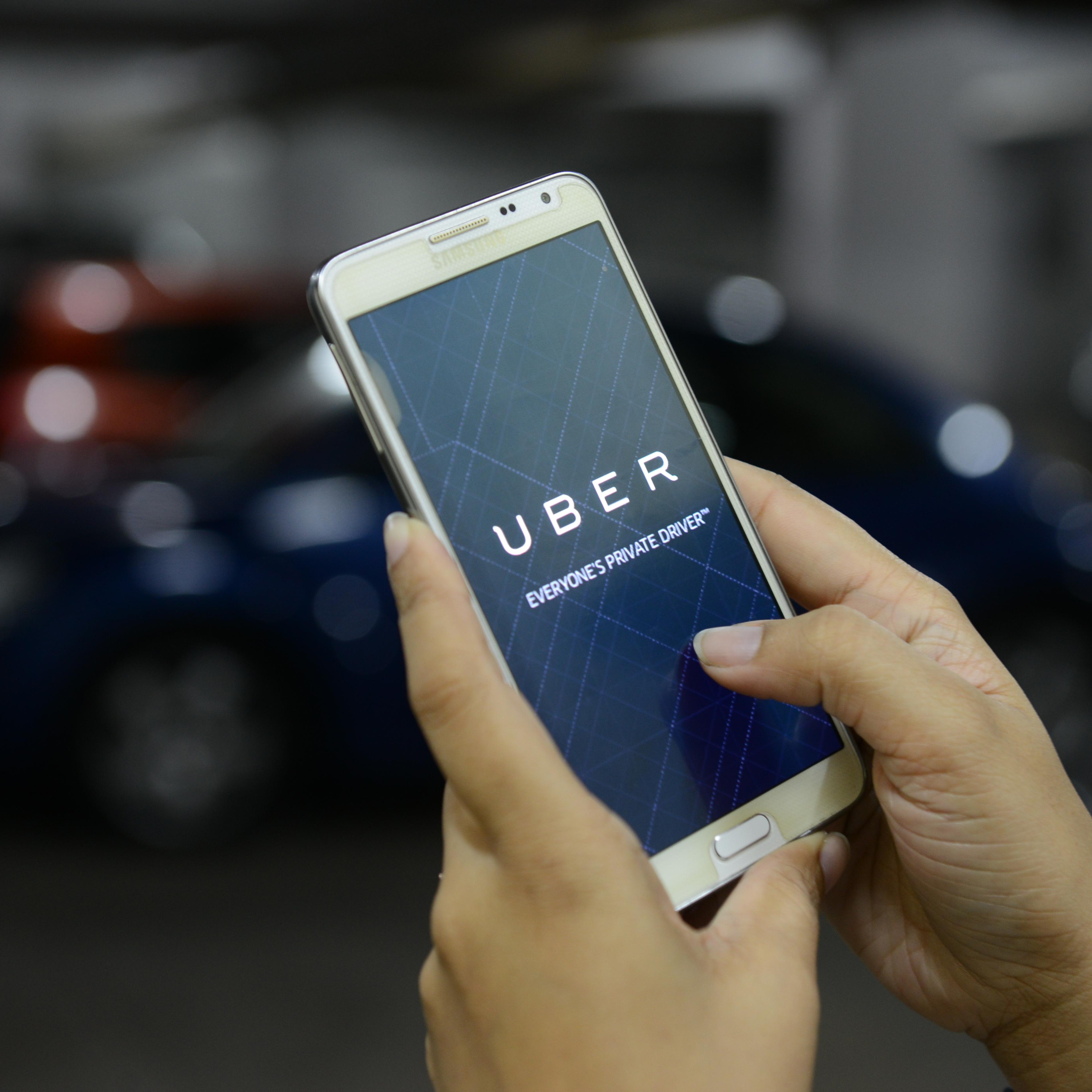 UBER cabs booking using mobile app on October 01 2015 in Bengaluru, India.