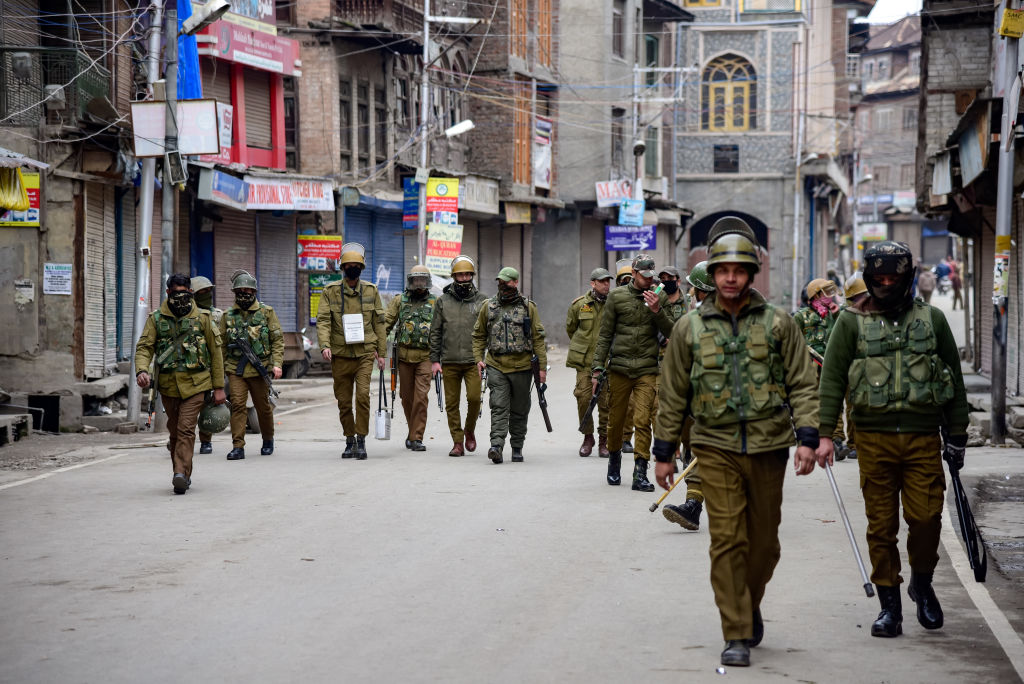 Indian policemen are seen patrolling during the clashes in