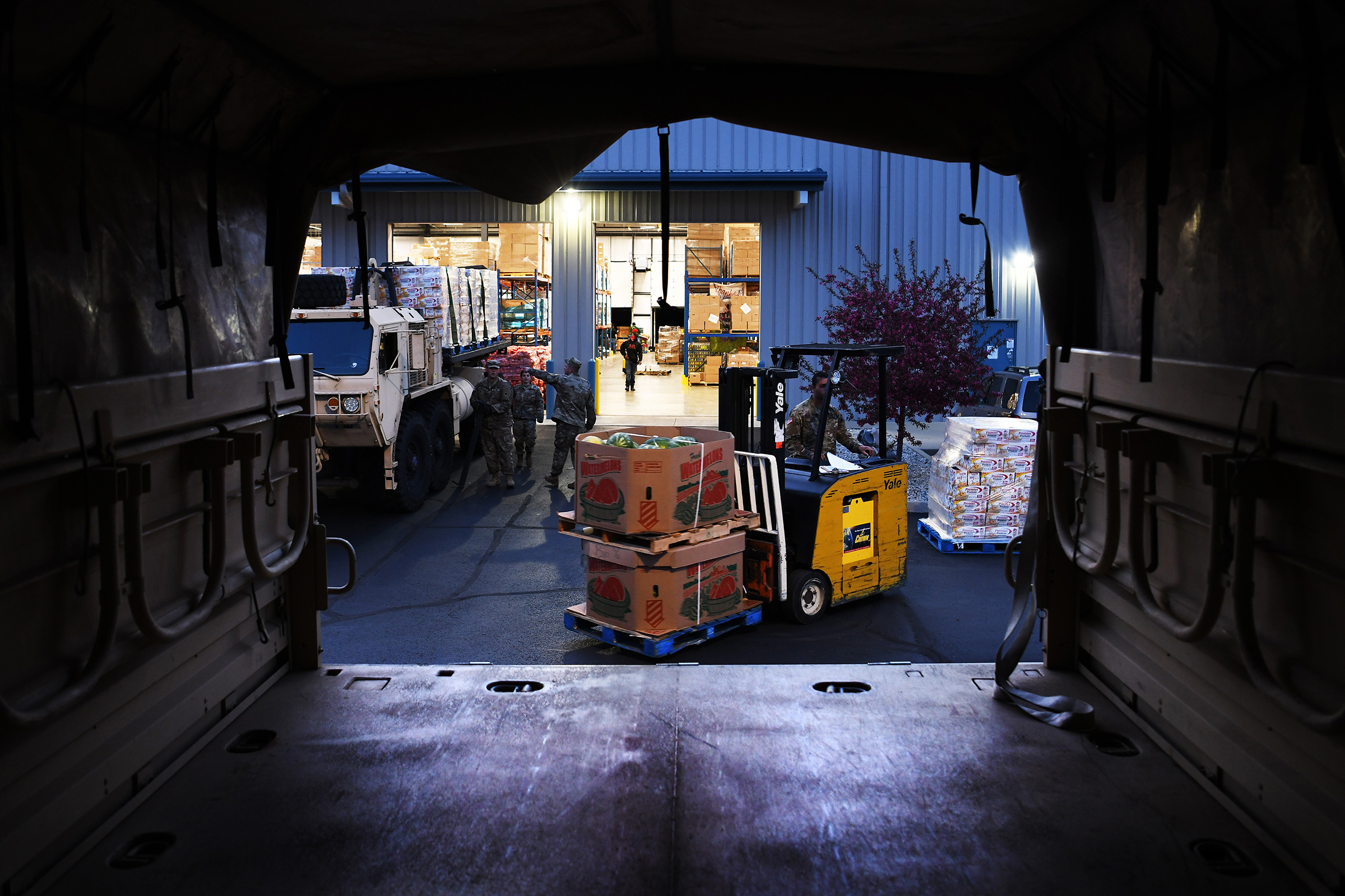 Soldiers assigned to the Ohio National Guard's 237th Brigade Support Battalion load food onto trucks at the Dayton Foodbank in Dayton, Ohio, on April 21, 2020.