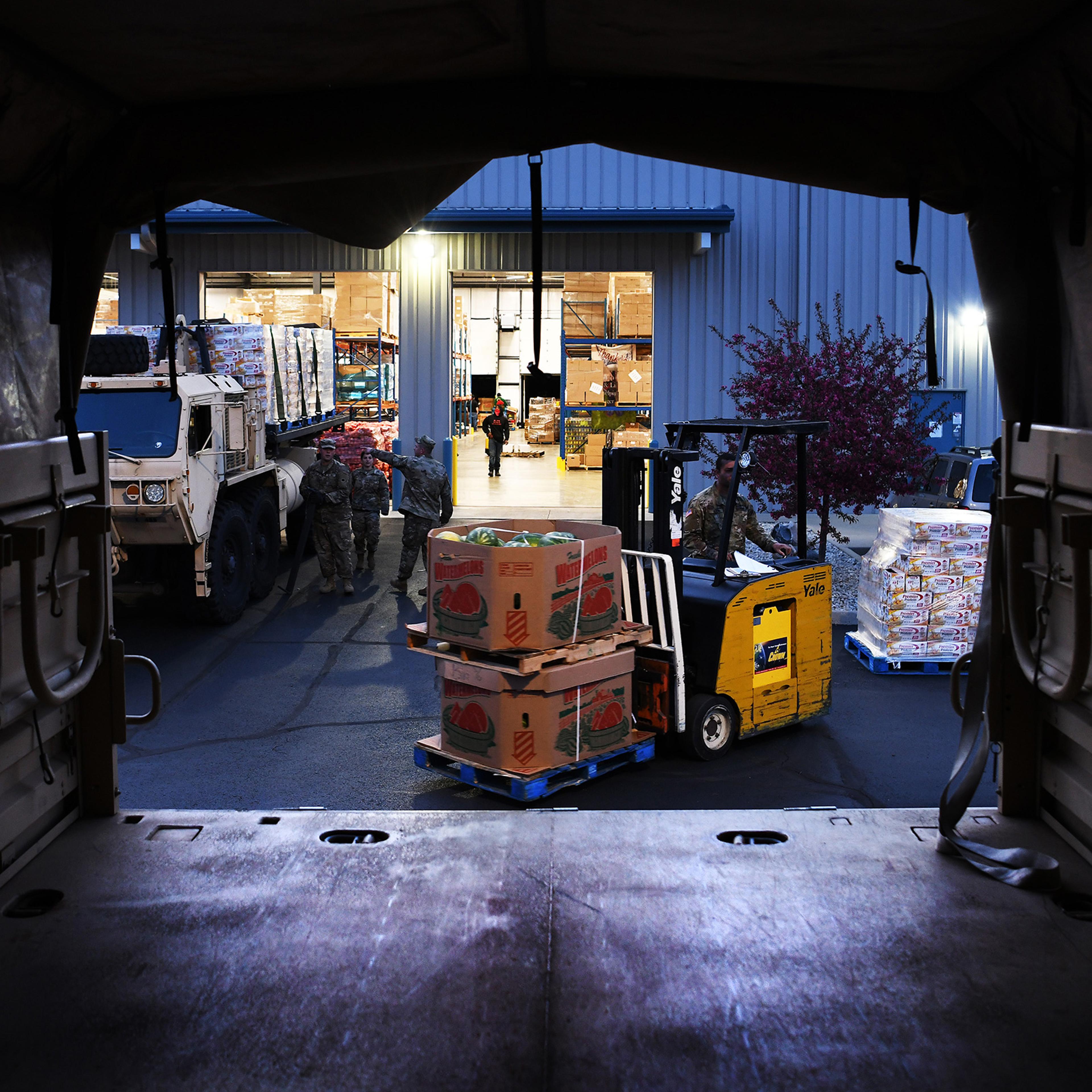 Soldiers assigned to the Ohio National Guard's 237th Brigade Support Battalion load food onto trucks at the Dayton Foodbank in Dayton, Ohio, on April 21, 2020.