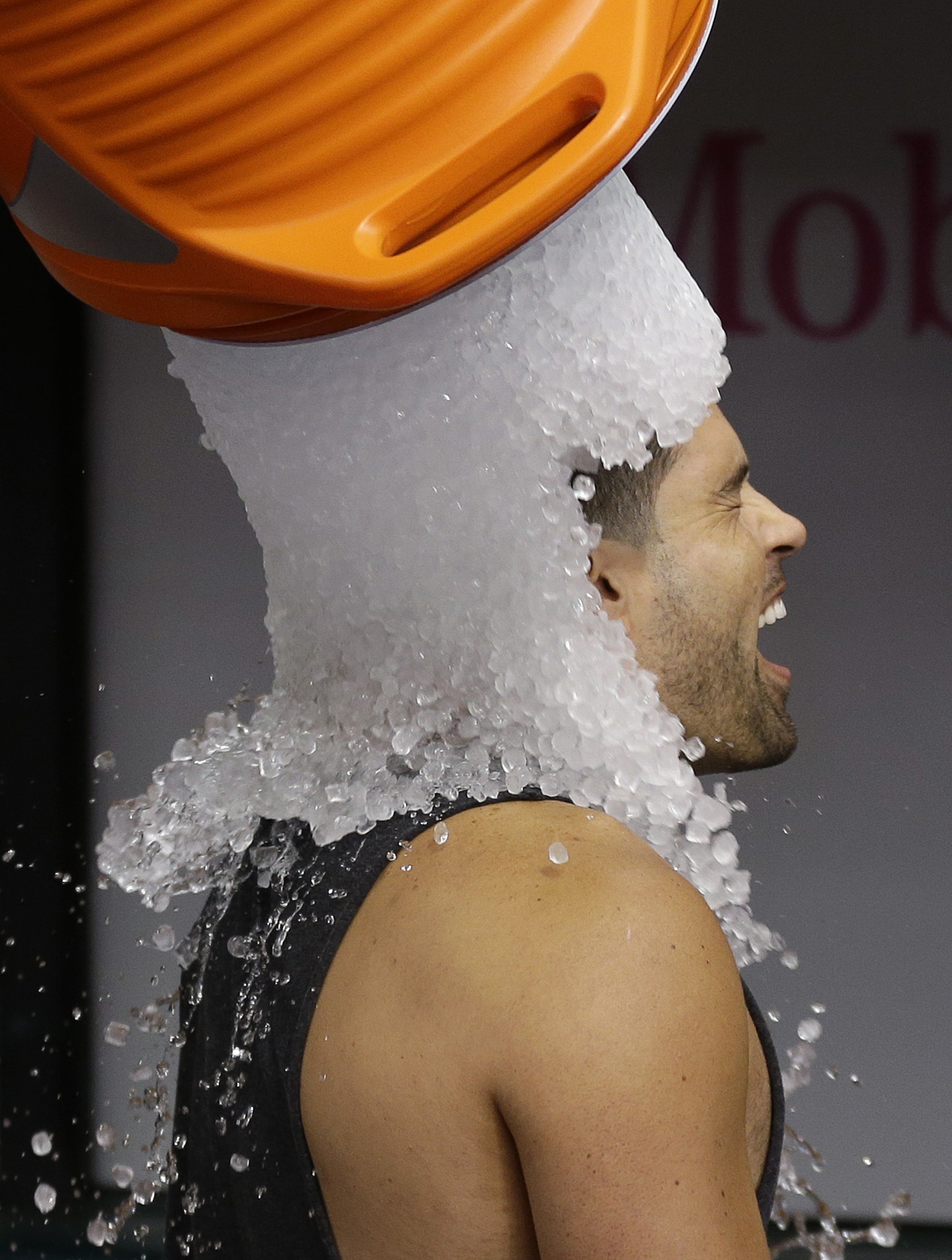 Tampa Bay Rays' David DeJesus gets a bucket of ice dumped on his head from video coordinator Chris Fernandez as part of the ALS Ice Bucket Challenge before a baseball game against the New York Yankees on Aug. 17, 2014, in St. Petersburg, Fla.