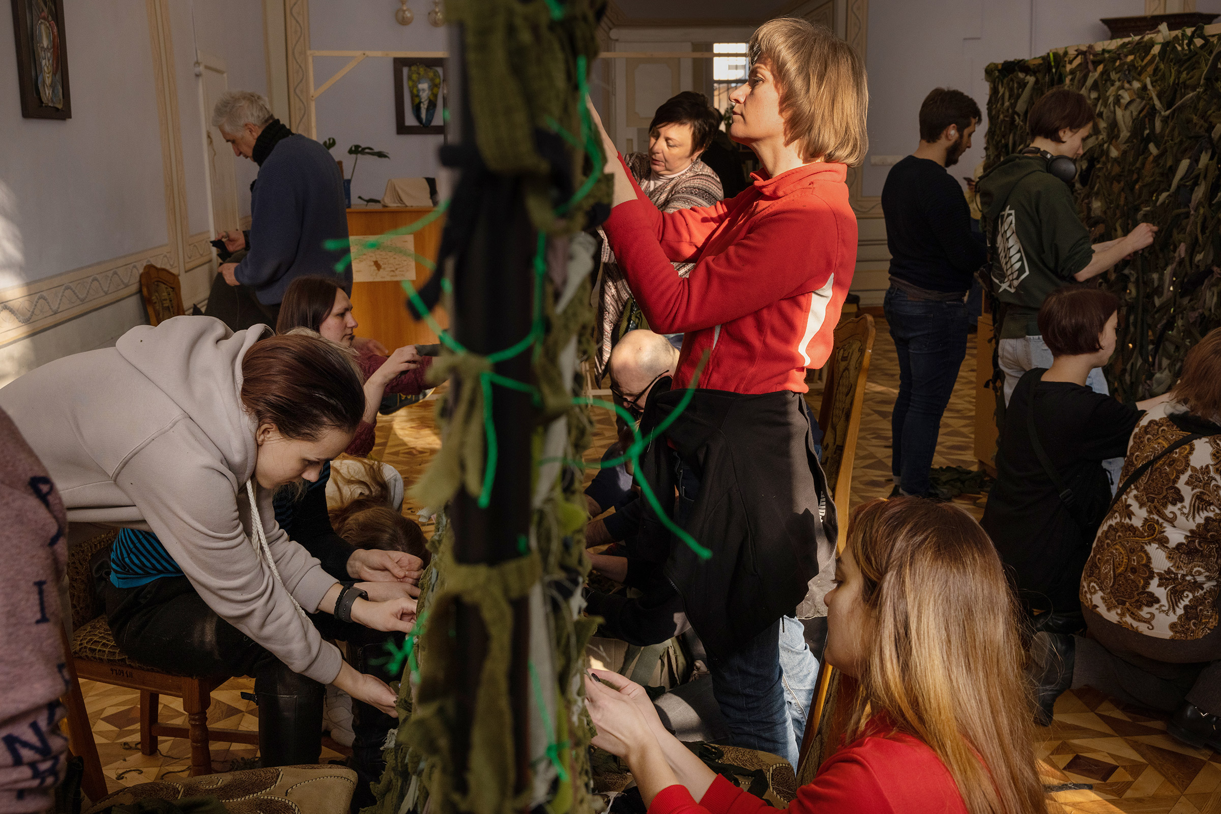 Volunteers at a library in central Lviv weave camouflage nets to send to the soldiers on the front lines. 