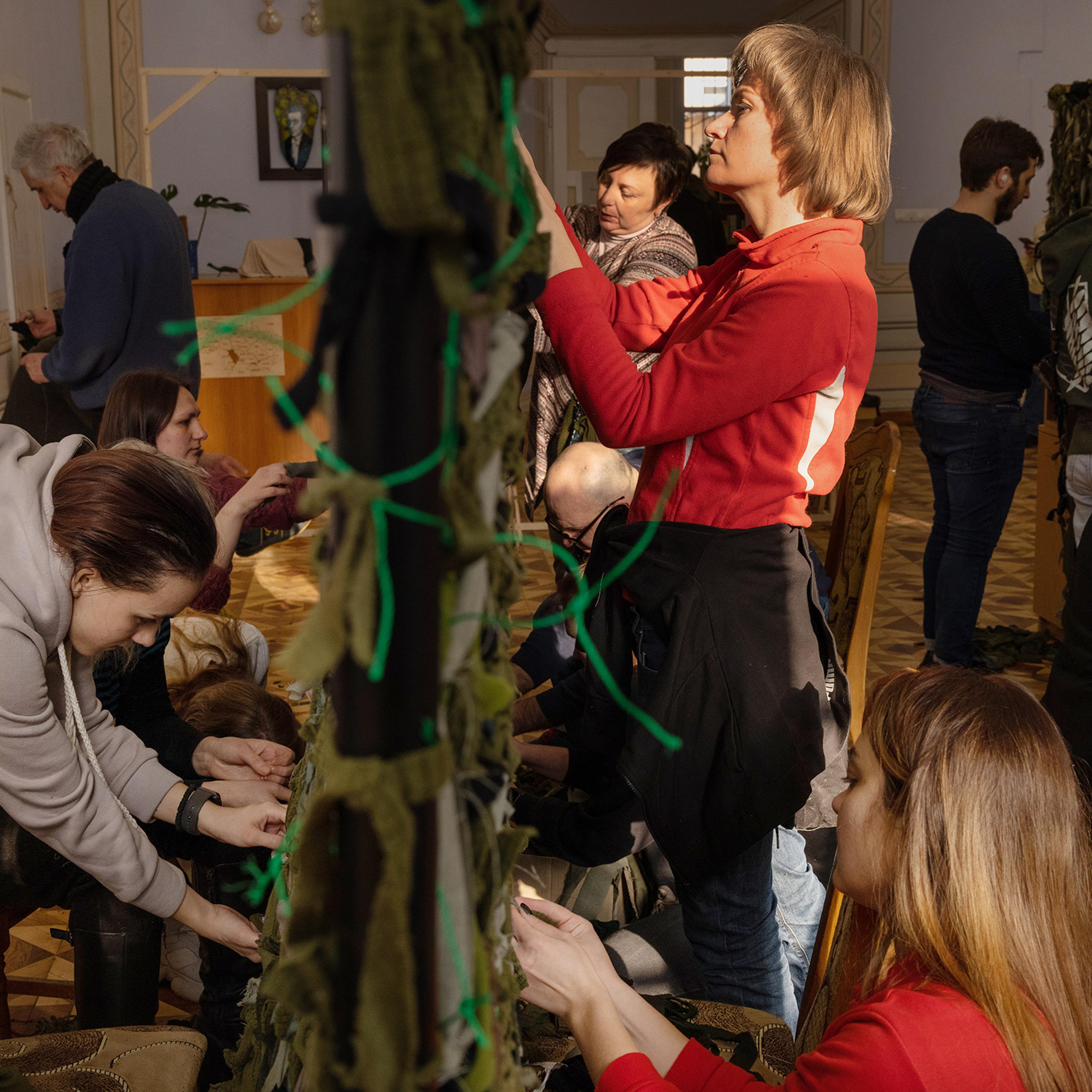 Volunteers at a library in central Lviv weave camouflage nets to send to the soldiers on the front lines.