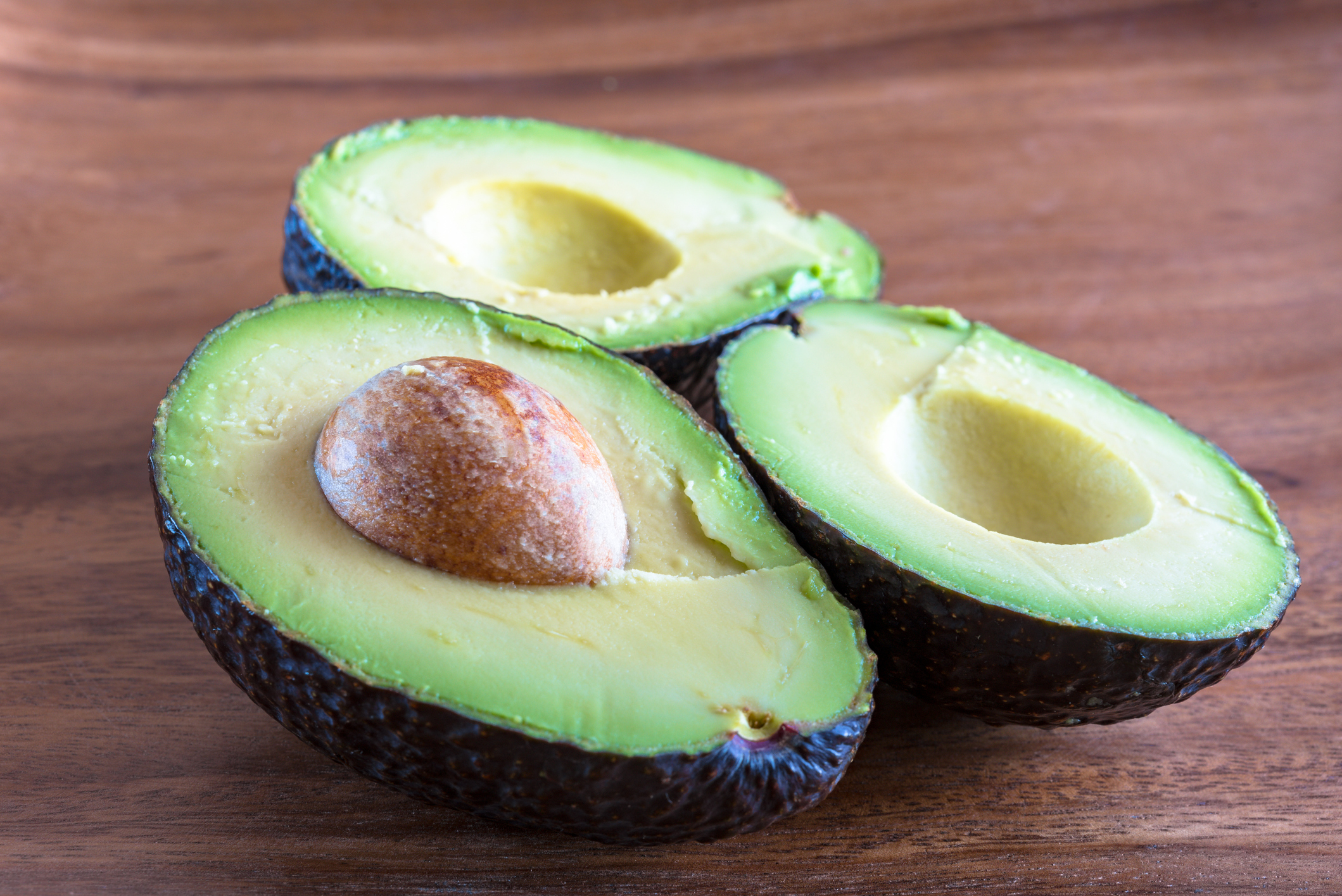 Healthy Eating: Avocado fruit cut in half displaying the seed