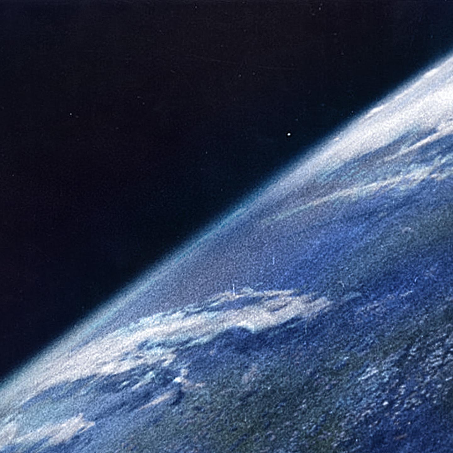 A colorized version of the first photo of the Earth taken from space