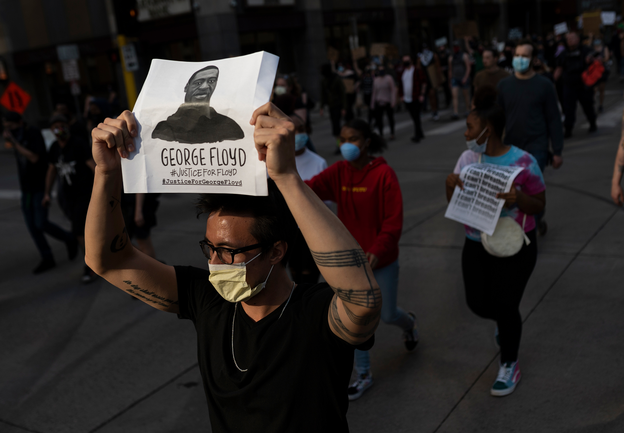 Protesters march through the street on May 28 in downtown Minneapolis. Police and protesters continued to clash for a third night after George Floyd was killed in police custody on Monday