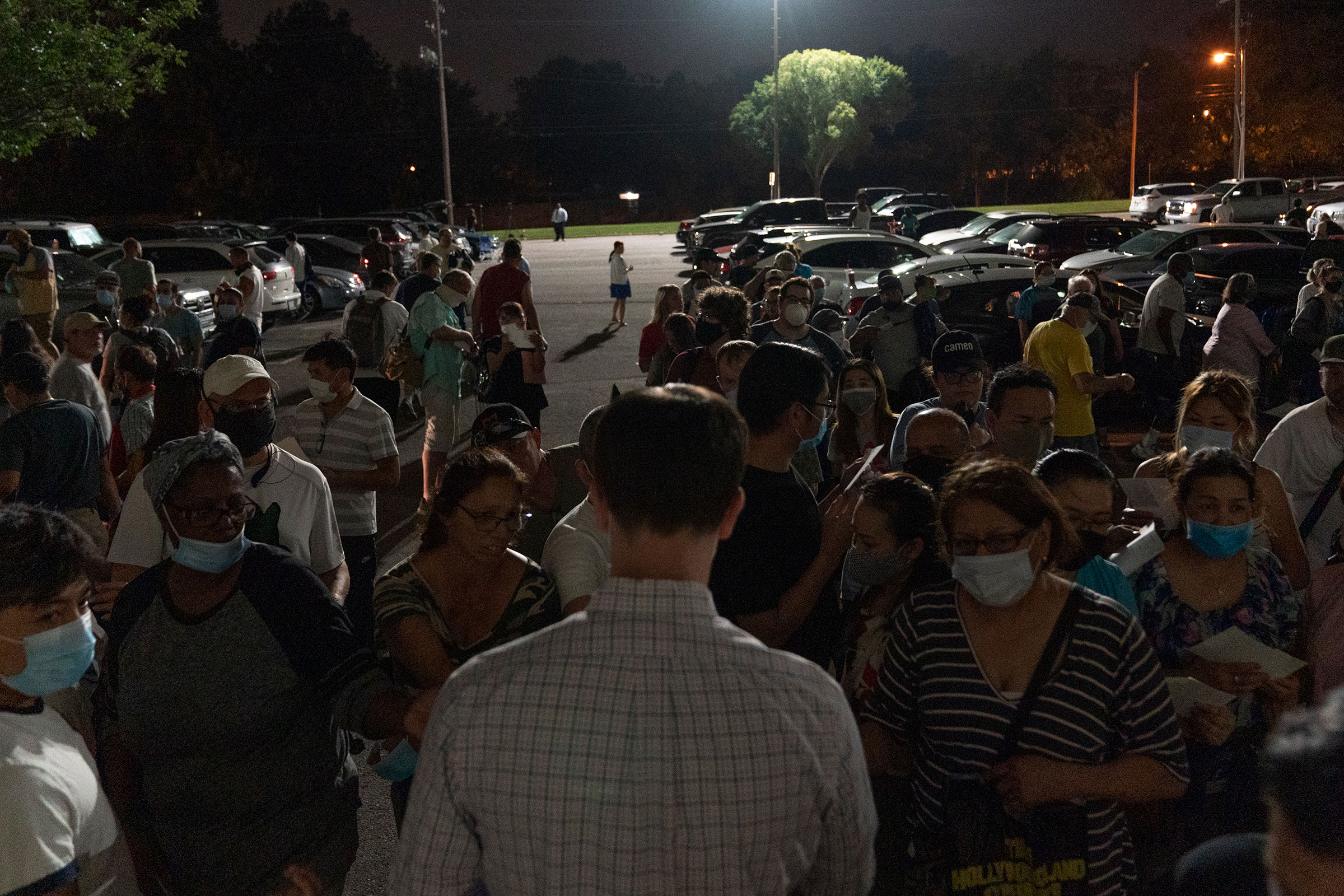 People crowd around an OESC employee to get a number at an unemployment event in Tulsa, Oklahoma
