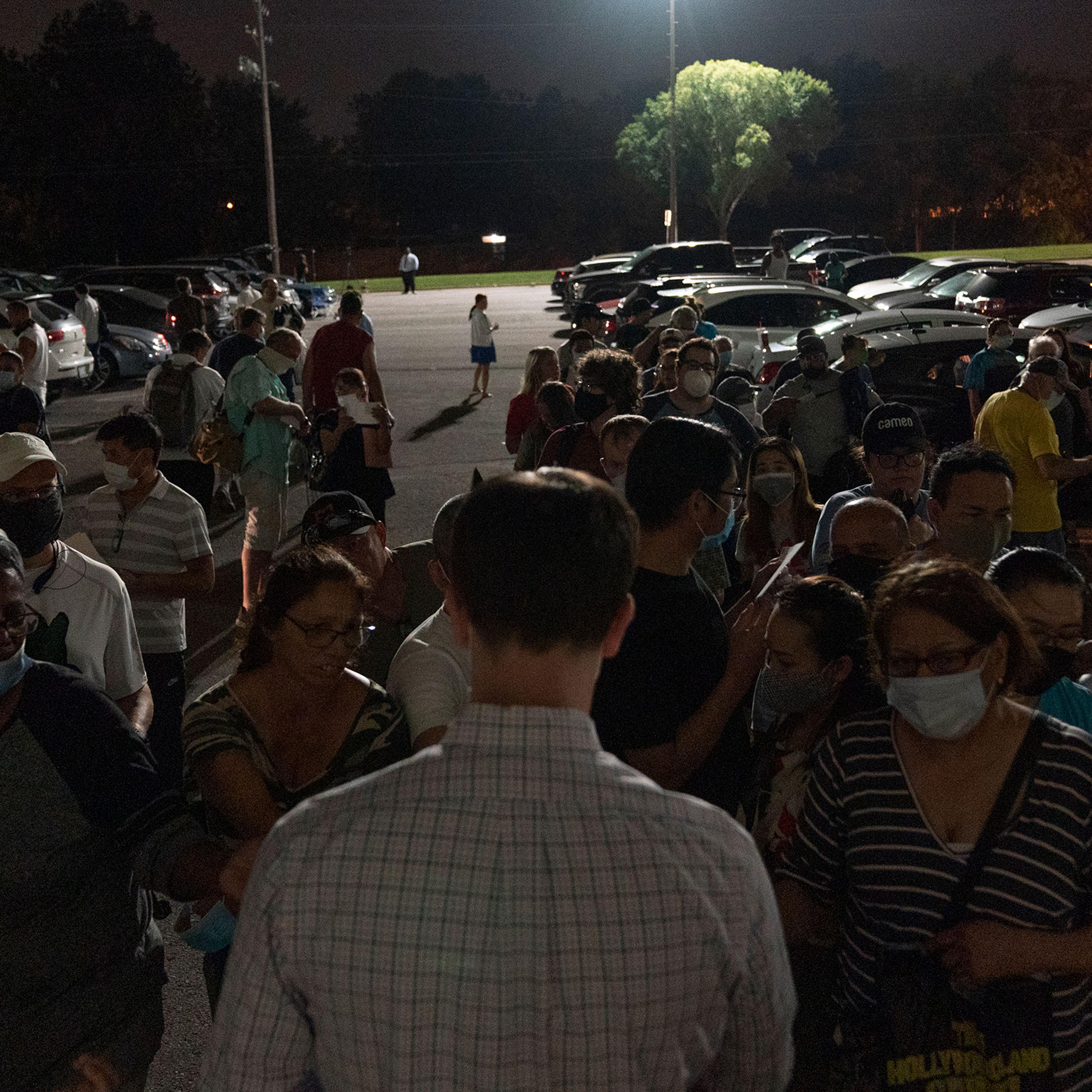 People crowd around an OESC employee to get a number at an unemployment event in Tulsa, Oklahoma