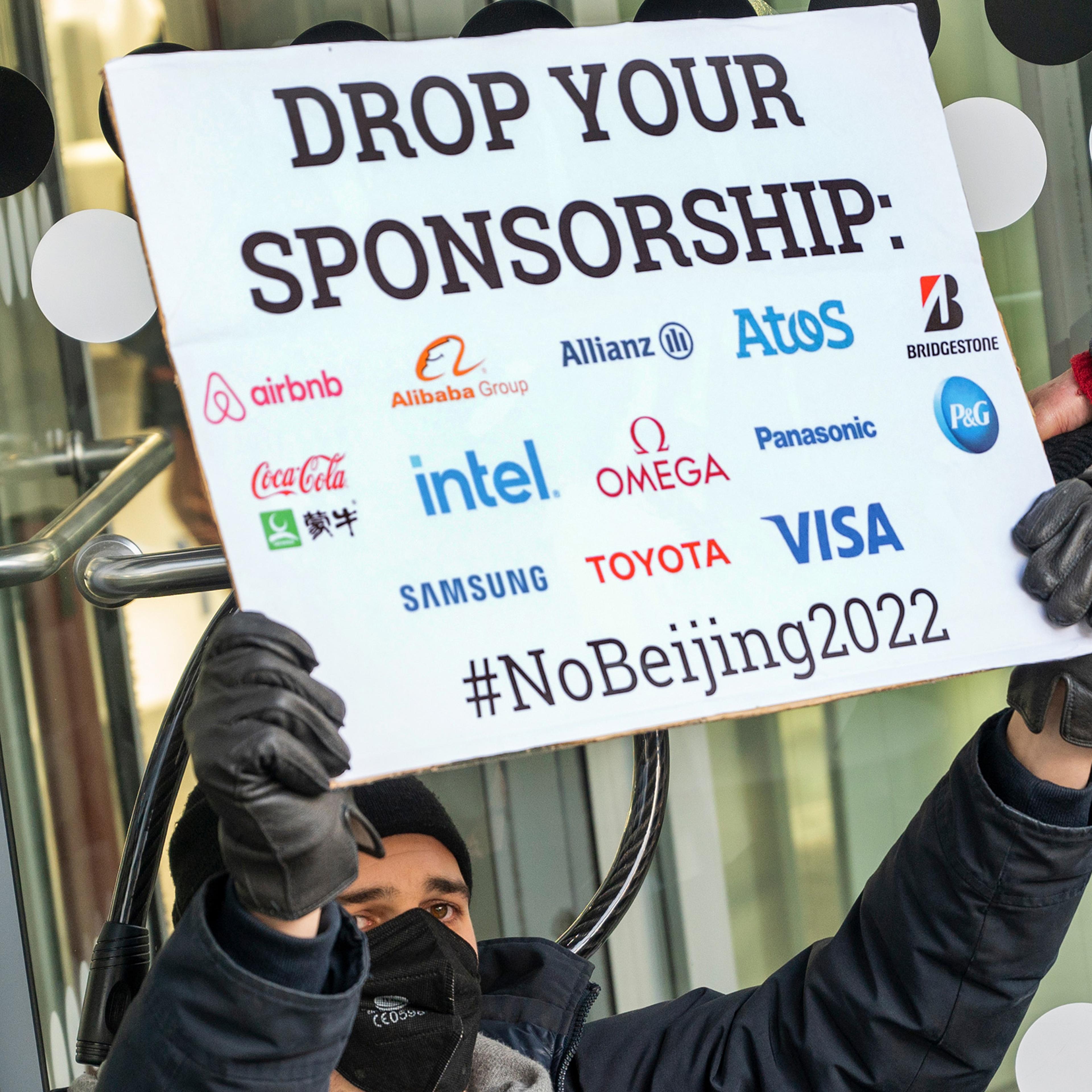 An activist protests in front of an Allianz Insurance branch in Berlin on Jan. 21, 2022.