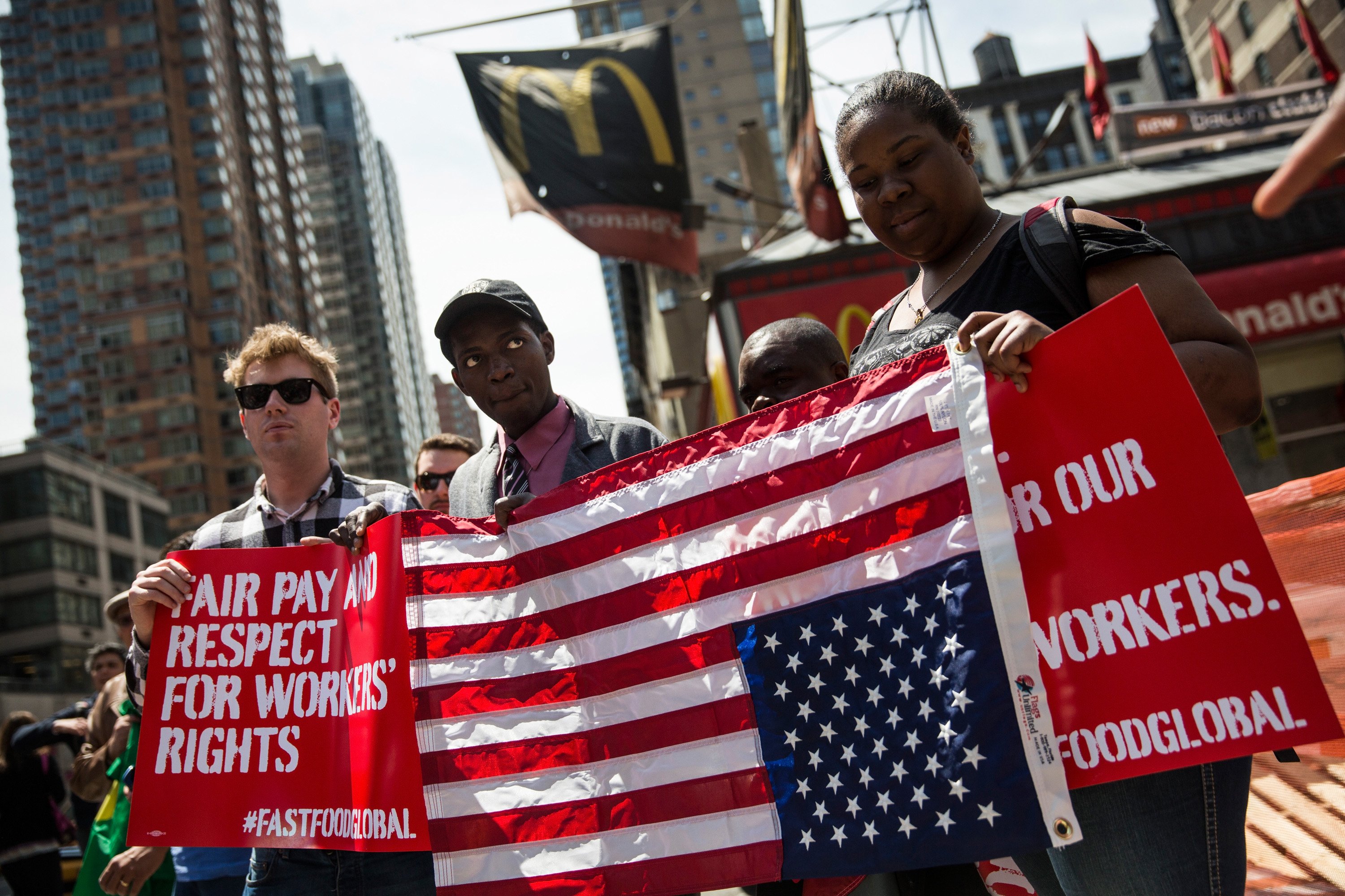 Protesters lobby for higher wages for fast food workers and urge fast food workers from around the globe to join their campaign outside a McDonalds on May 7, 2014 in New York City.