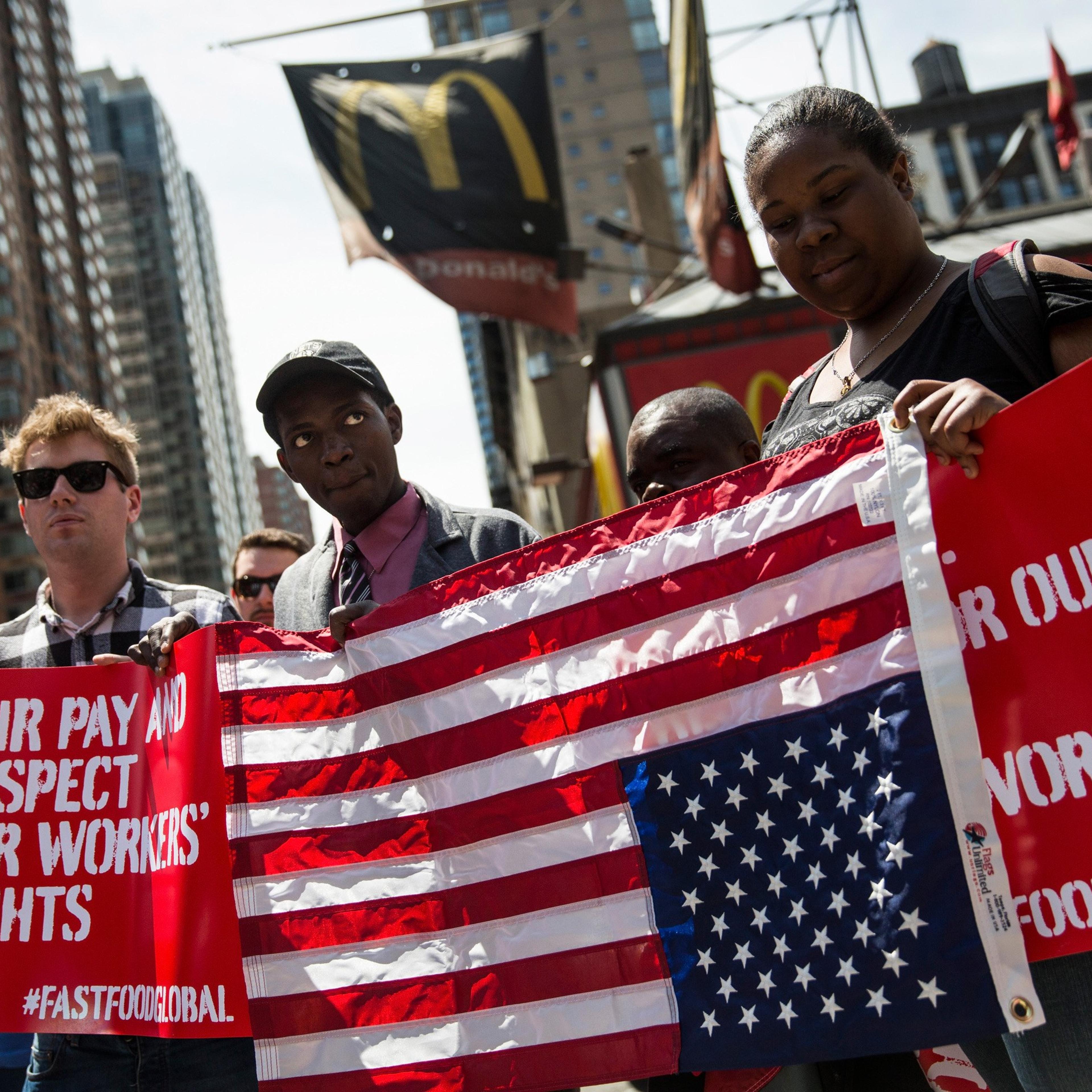 Protesters lobby for higher wages for fast food workers and urge fast food workers from around the globe to join their campaign outside a McDonalds on May 7, 2014 in New York City.