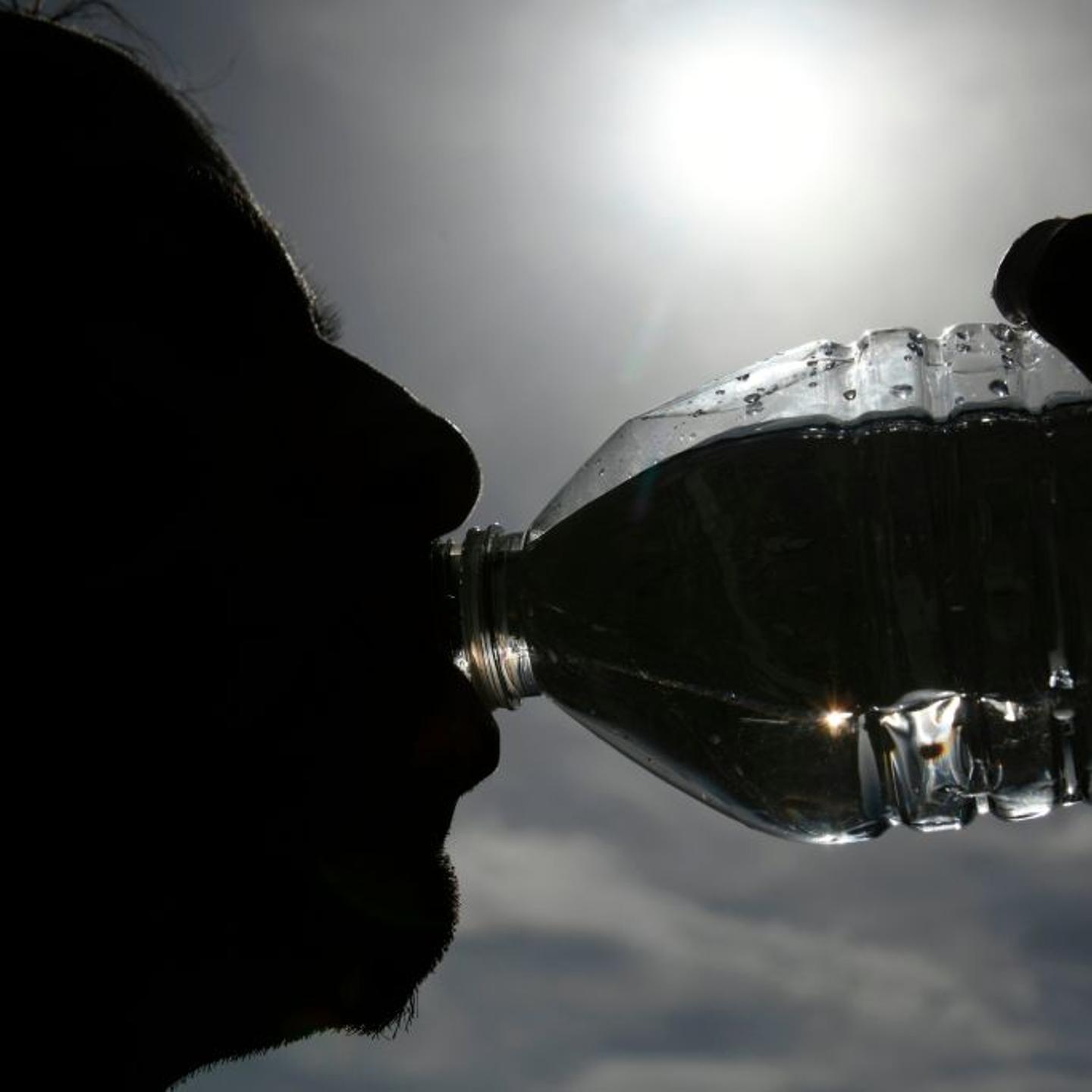 A person drinking a bottle of water