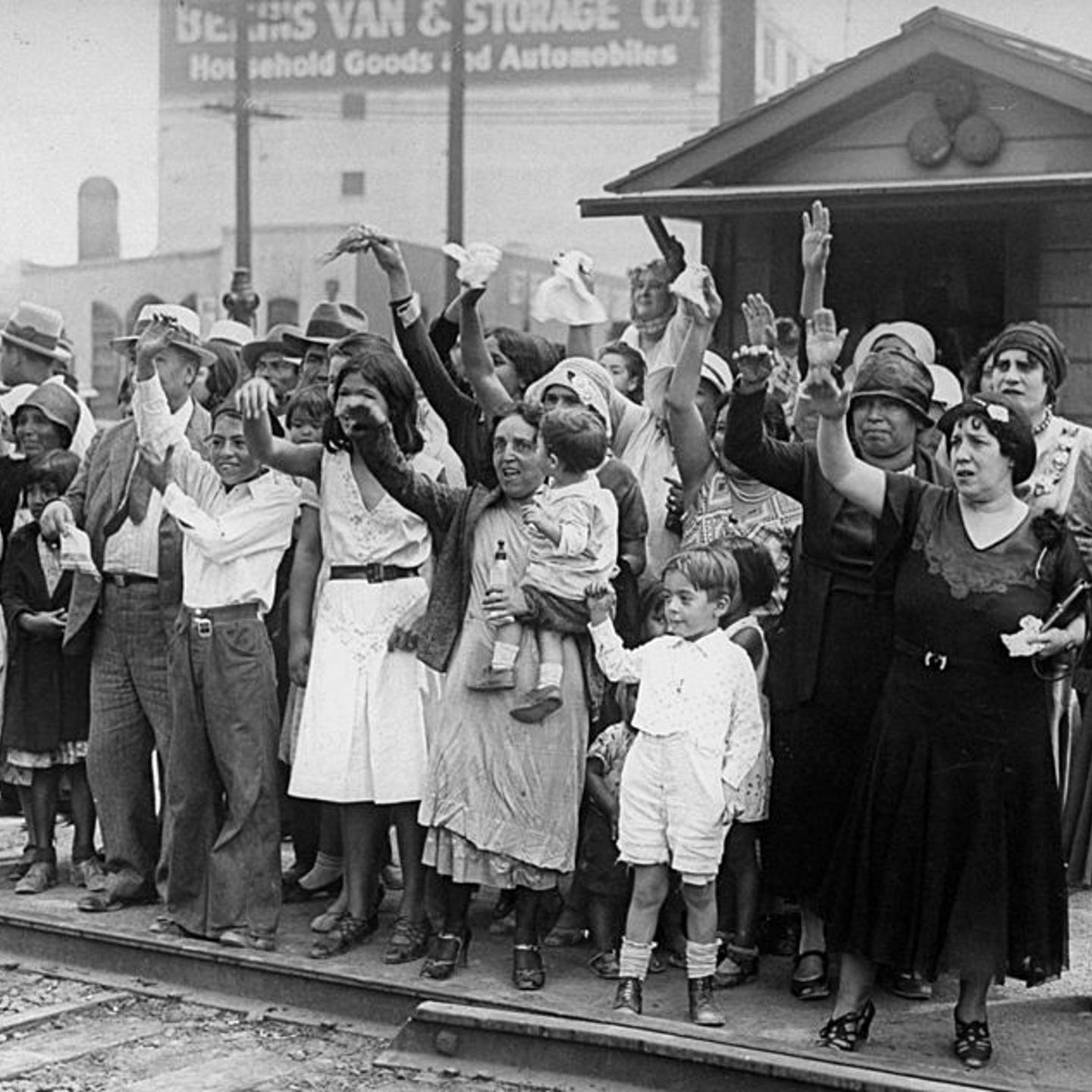 Relatives and friends wave goodbye to a train carrying 1,500