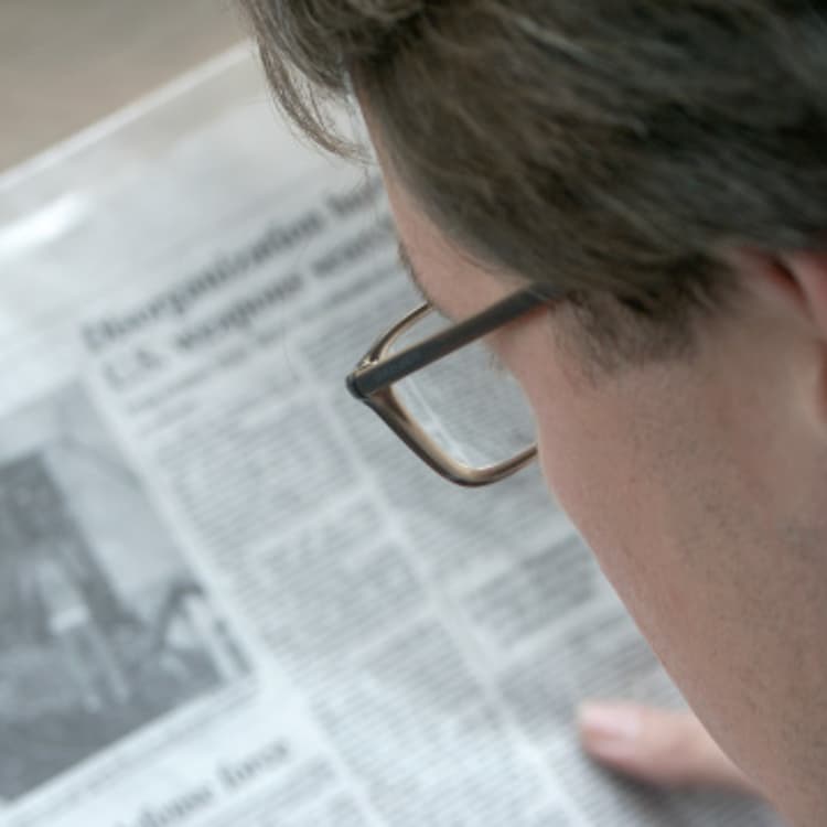 man-reading-newspaper-close-up