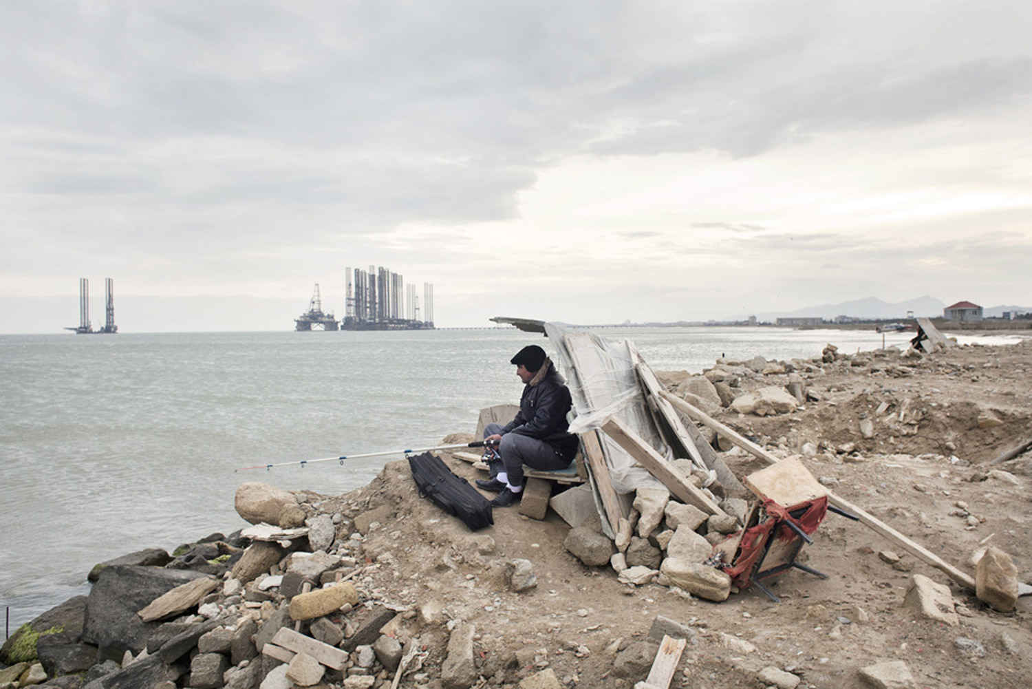 A man fishes at Sahil beach near Baku, Azerbaijan, 2010. 