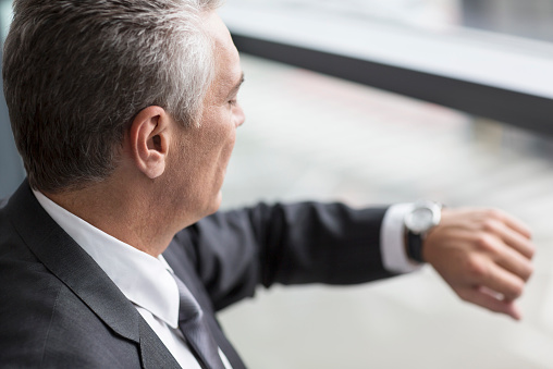 businessman-looking-wrist-watch