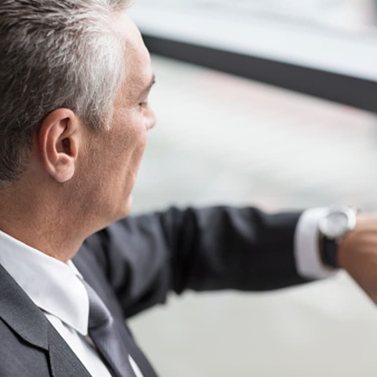 businessman-looking-wrist-watch