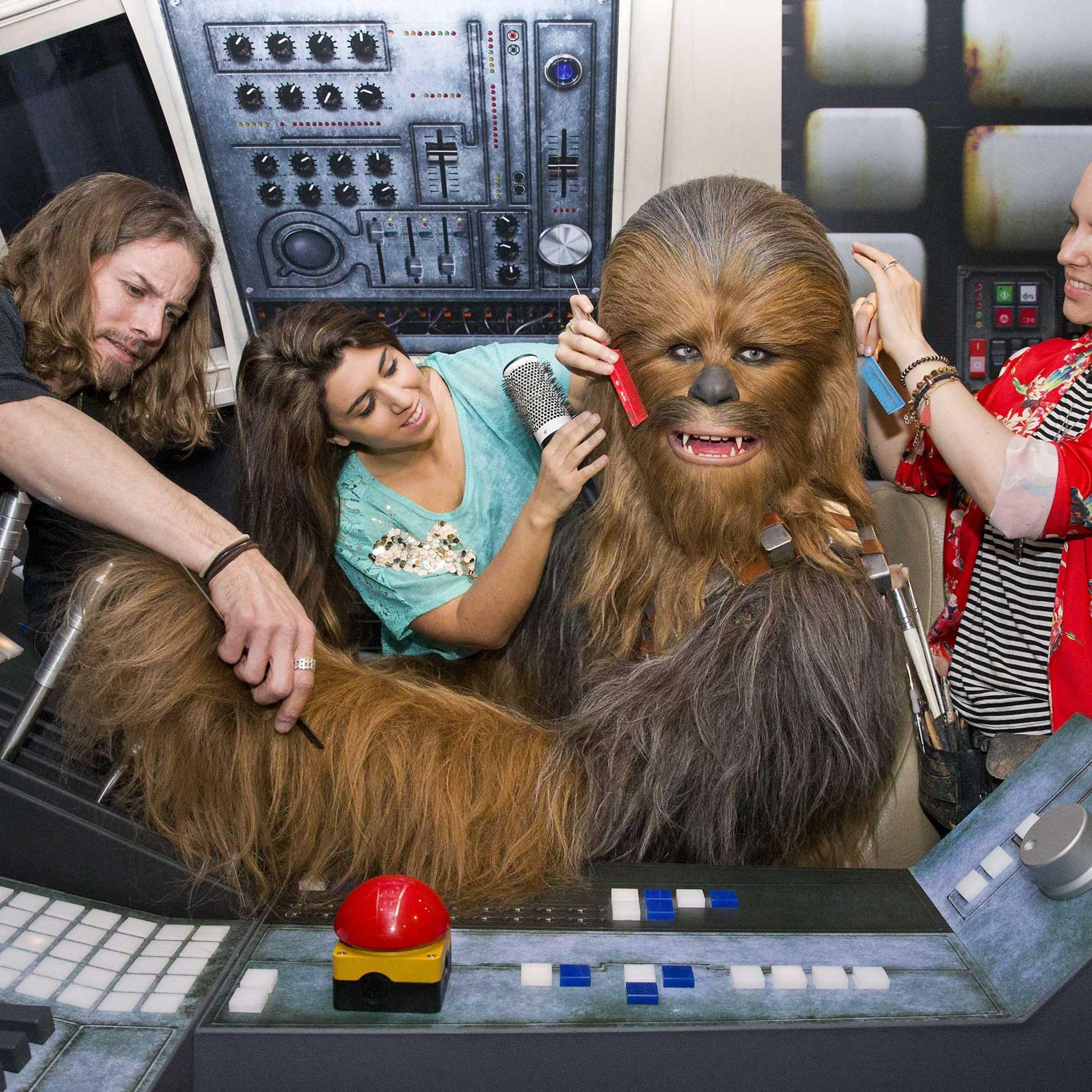 Members of staff put the finishing touches to the wax figure of Star Wars character Chewbacca at the Star Wars At Madame Tussauds attraction in London on May 12, 2015.