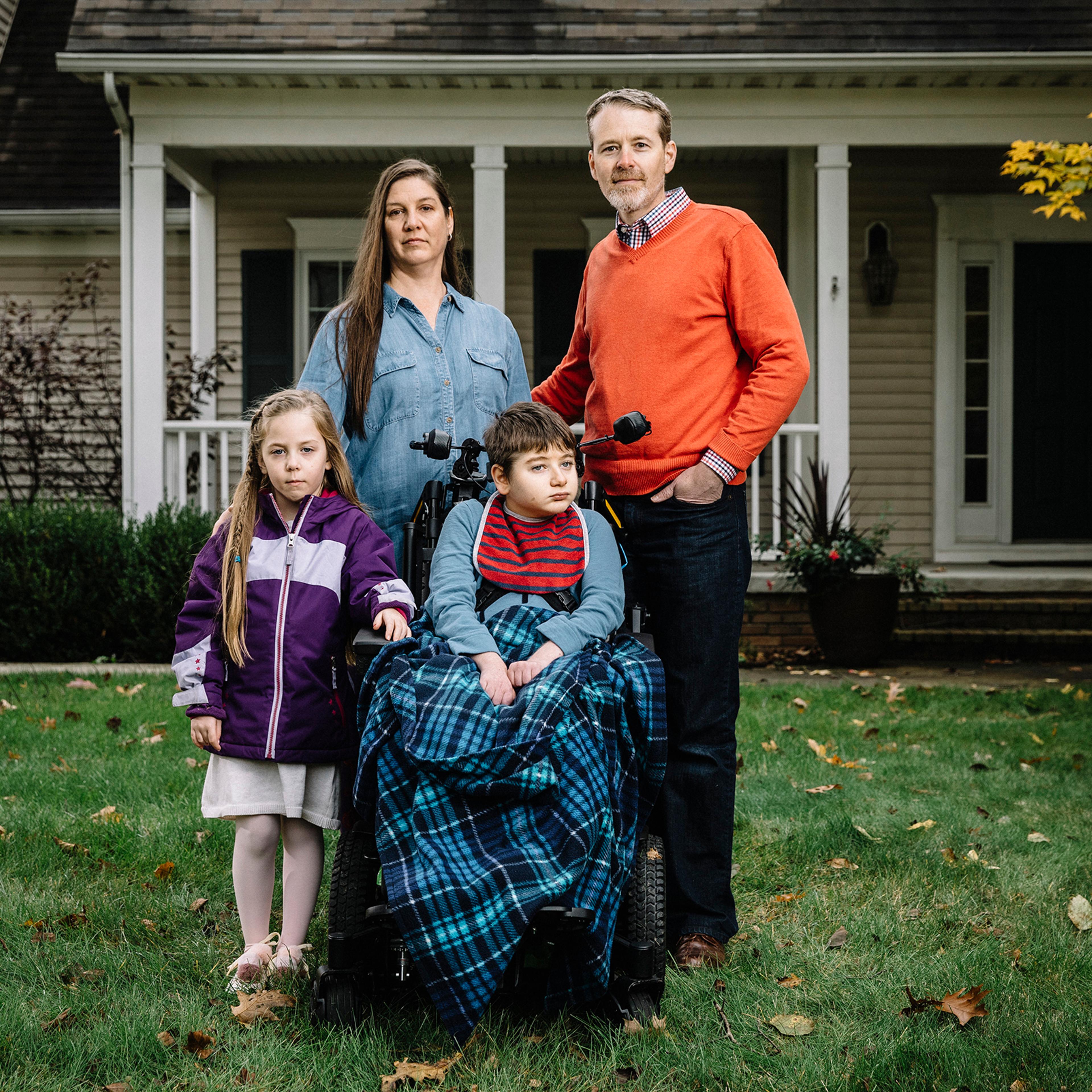 Christine and Larry Callahan, with kids Claire, 5, and Andrew, 11, in front of their home in Cleveland’s northeast suburbs