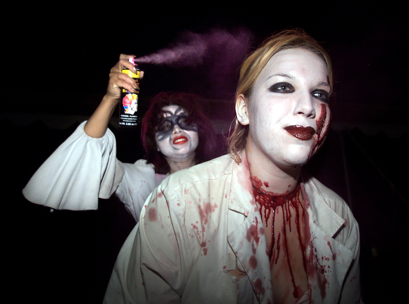 FrightFair actor Jennifer Ubillus (CQ), 22, left, sprays hair coloring on coworker Sarah Utso (CQ),