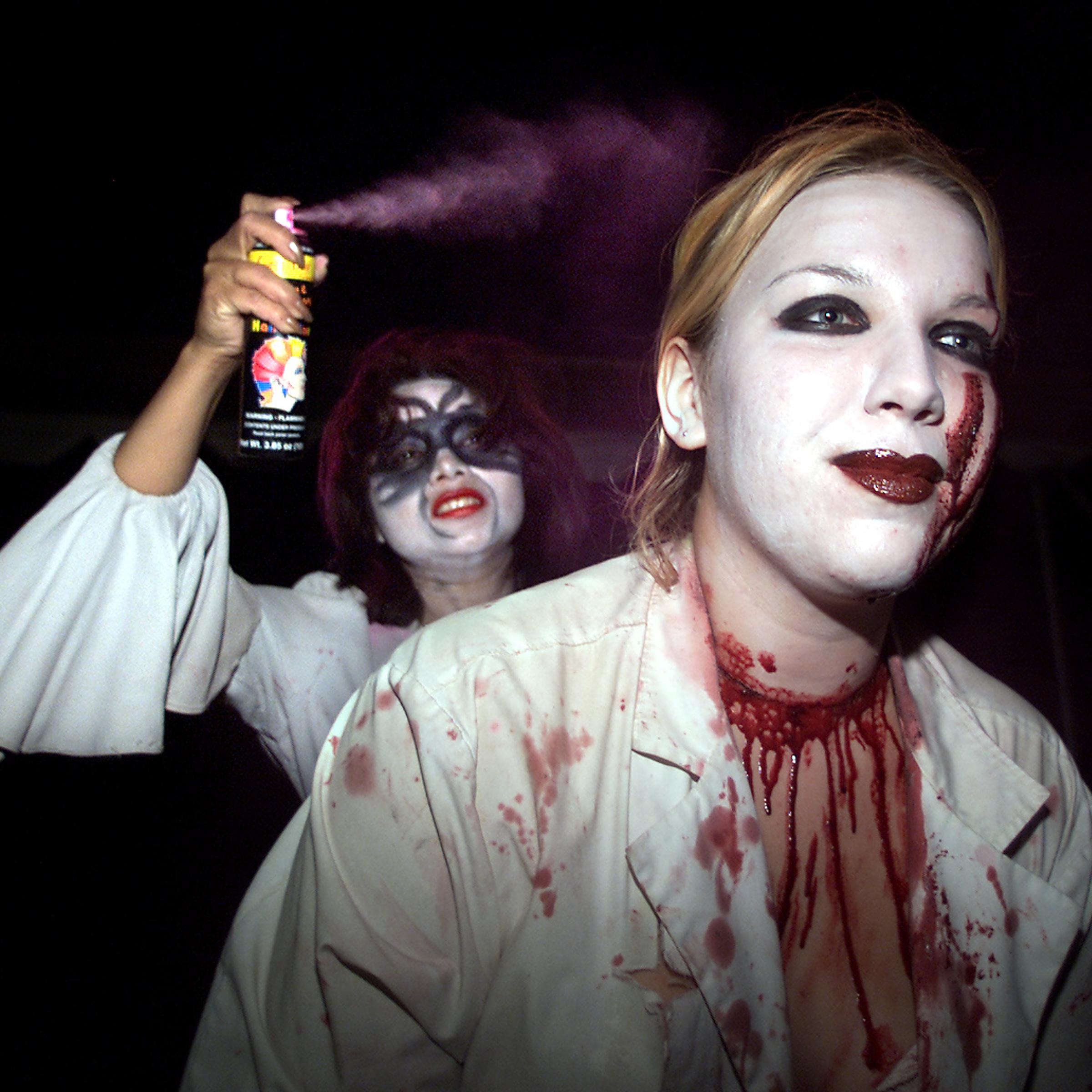FrightFair actor Jennifer Ubillus (CQ), 22, left, sprays hair coloring on coworker Sarah Utso (CQ),
