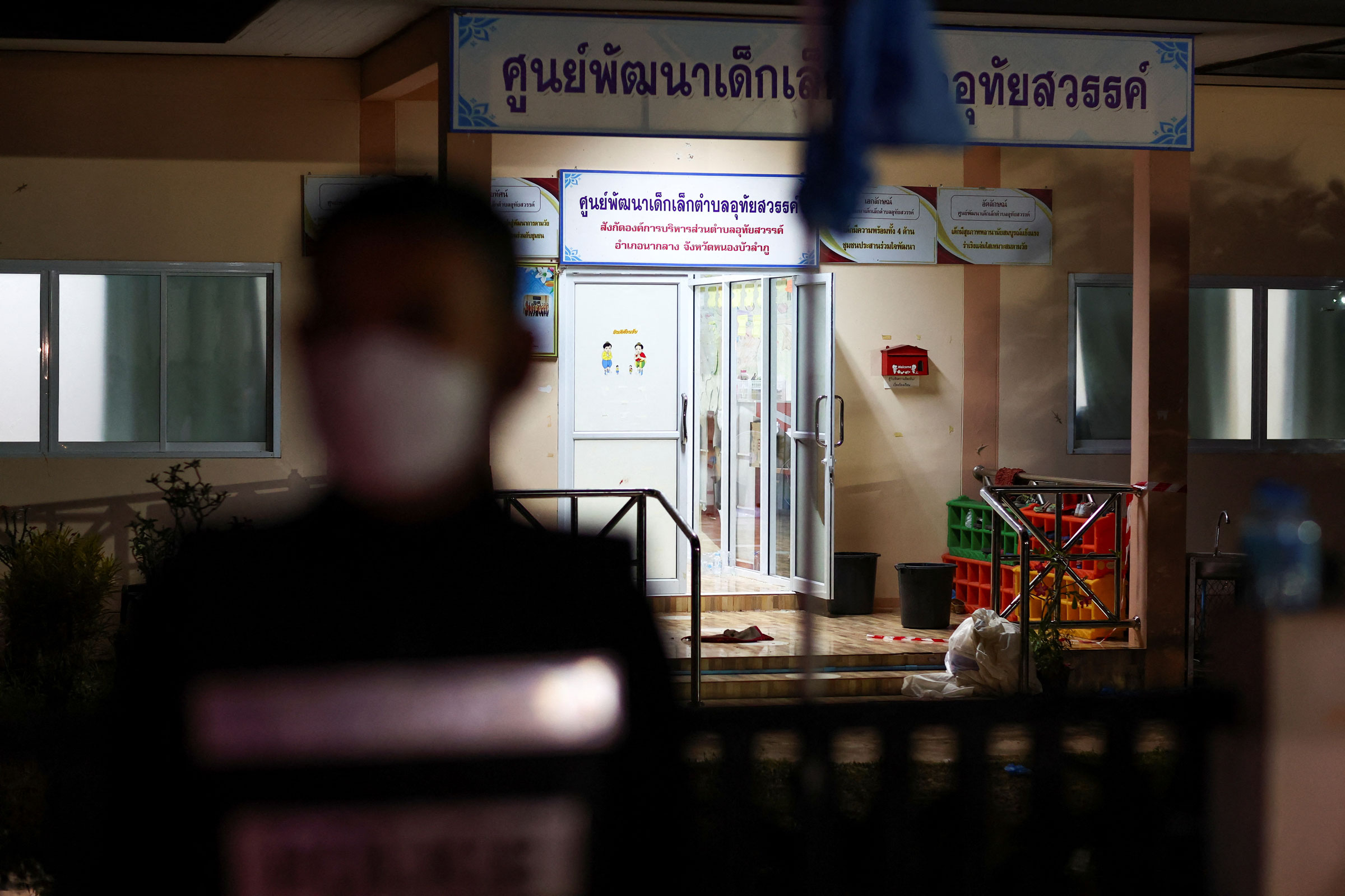 A police officer stands outside a day care center which was the scene of a mass shooting, in the town of Uthai Sawan, around 500 km northeast of Bangkok in the province of Nong Bua Lam Phu, Thailand, on Oct. 6, 2022.