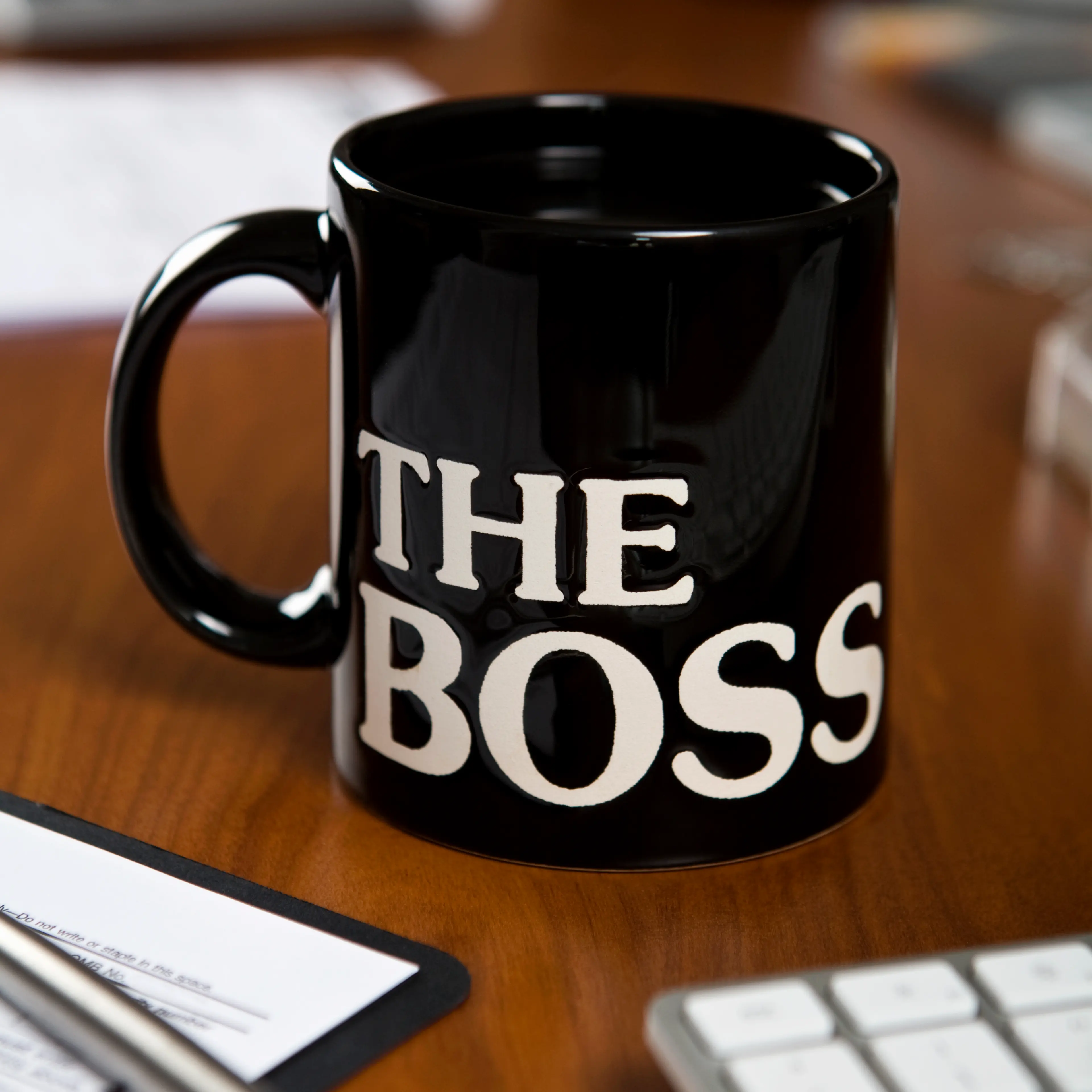 The Boss mug on a desk