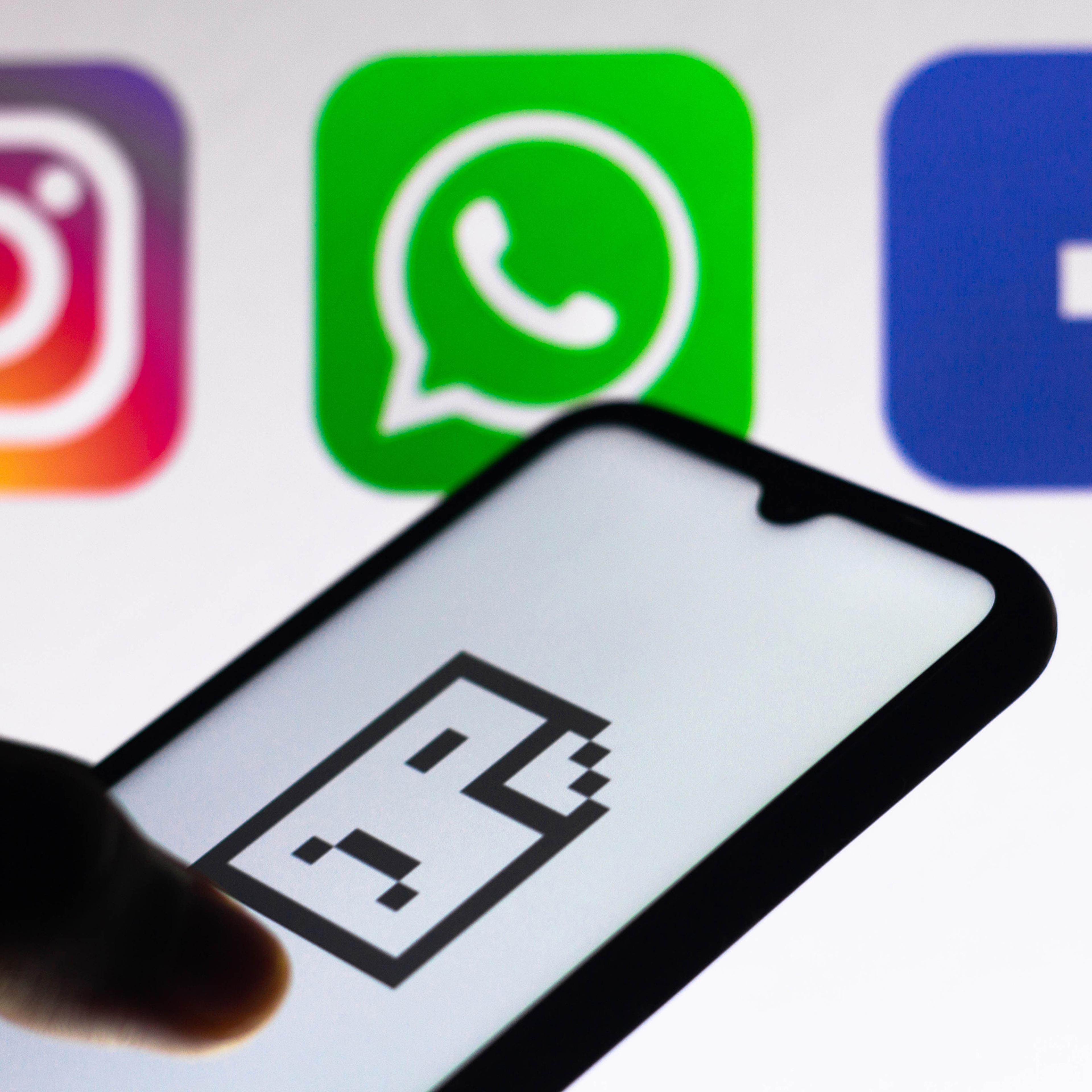 An error icon on a smartphone screen is seen with Instagram, WhatsApp and Facebook logos in the background.