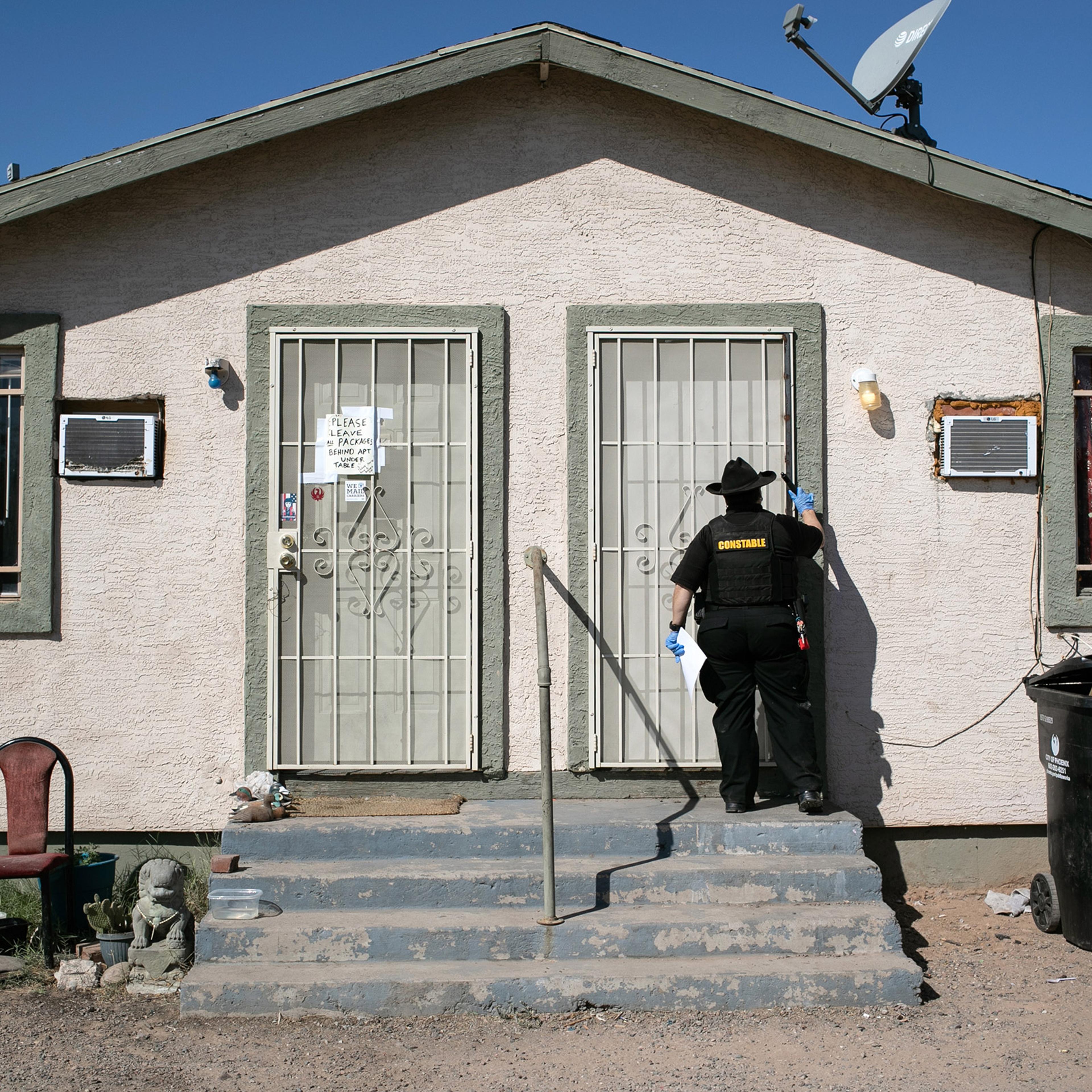 Maricopa County constable Darlene Martinez knocks on a door before posting an eviction order on October 1, 2020 in Phoenix, Az.