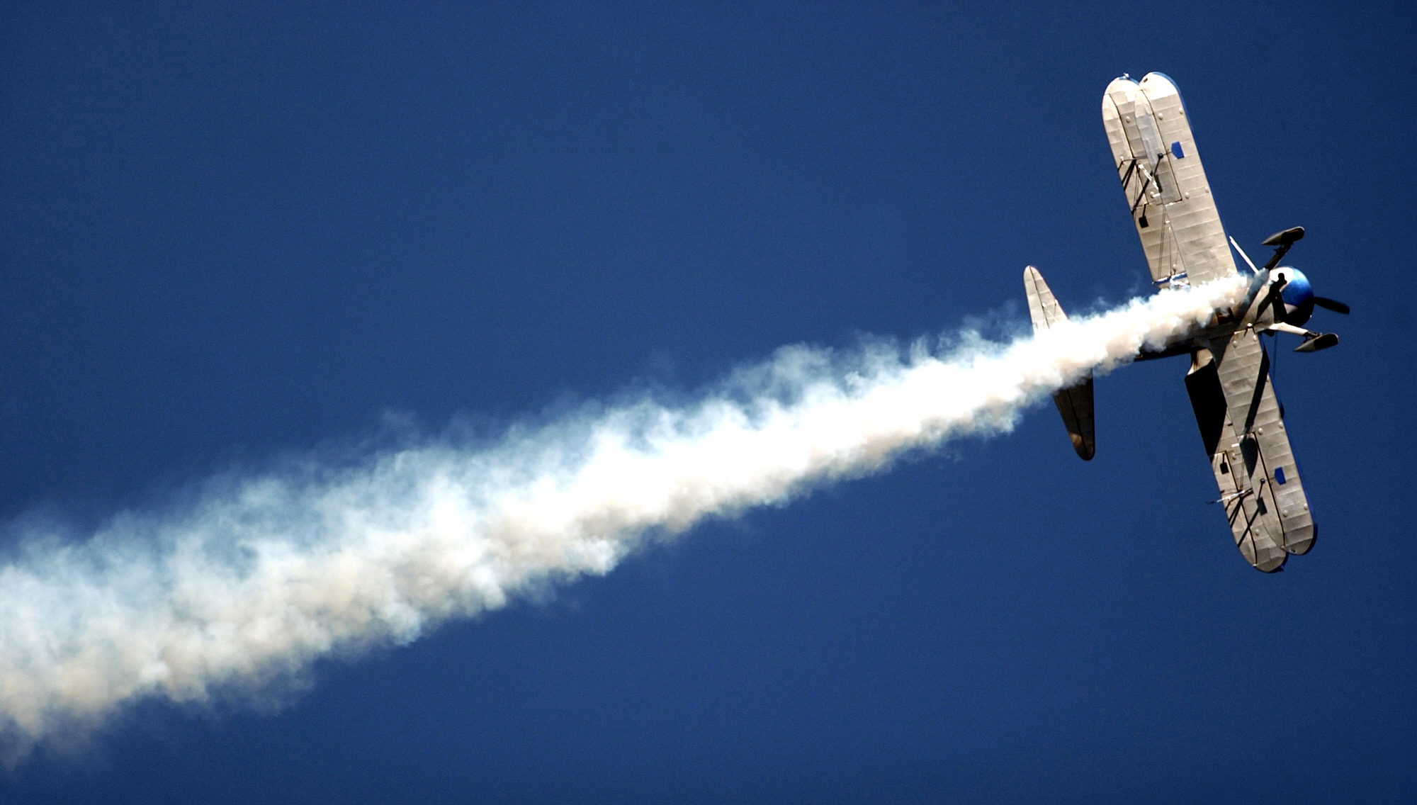Pilot Eddie Andreini flies his Boeing Stearman over the crowd at Vandenberg Airforce Base, Calif., on Oct. 30, 2004, during the Western Air and Space Show.
