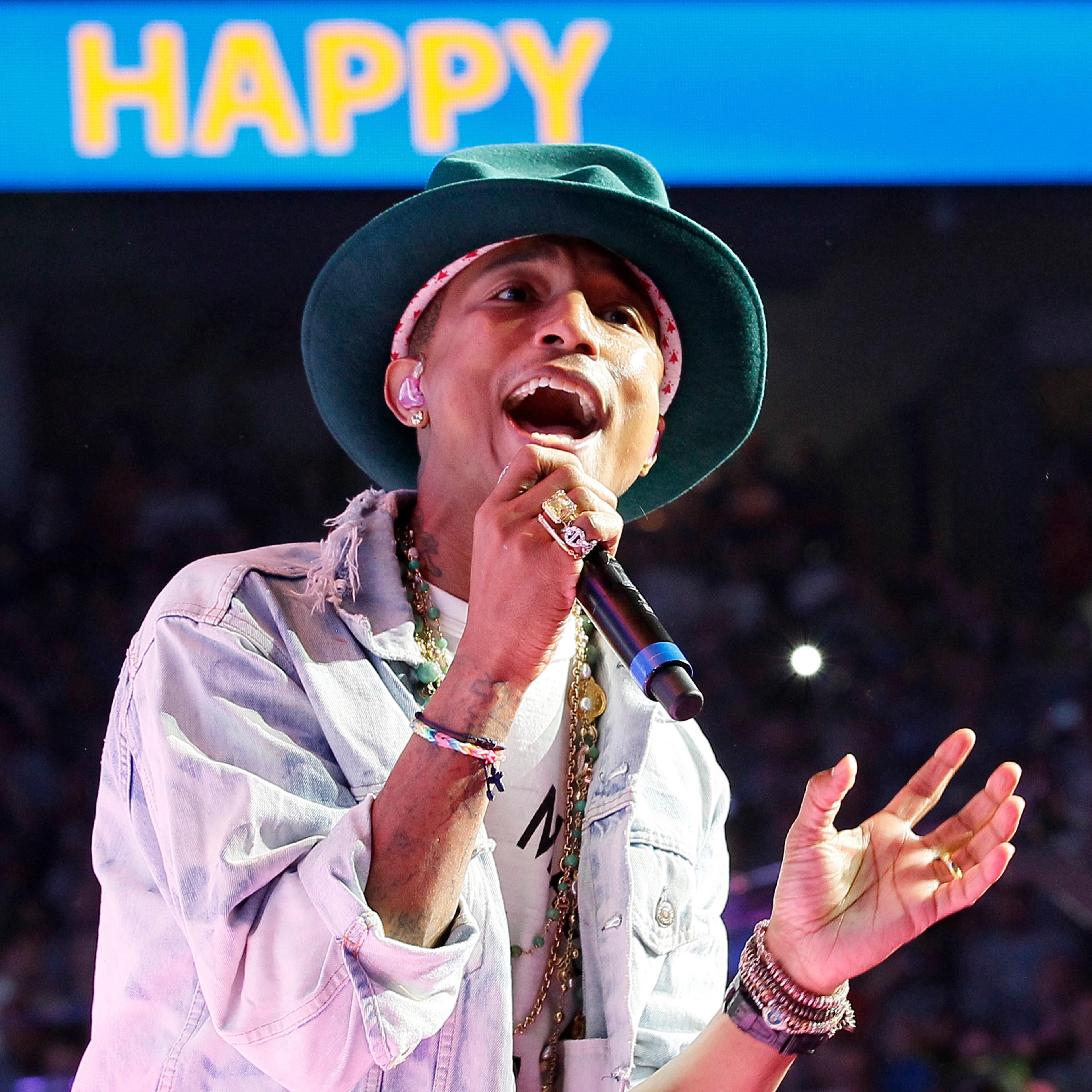 Singer Pharrell Williams performs his hit song "Happy" at the Walmart annual shareholders meeting in Fayetteville
