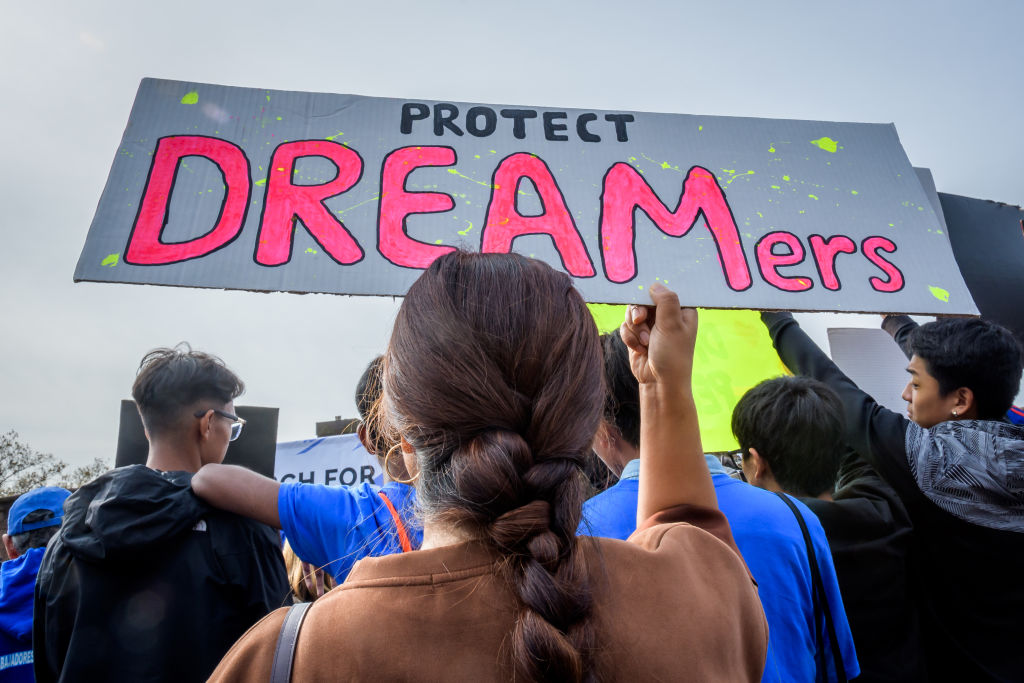 Participant holding a protest sign at the rally. Immigration