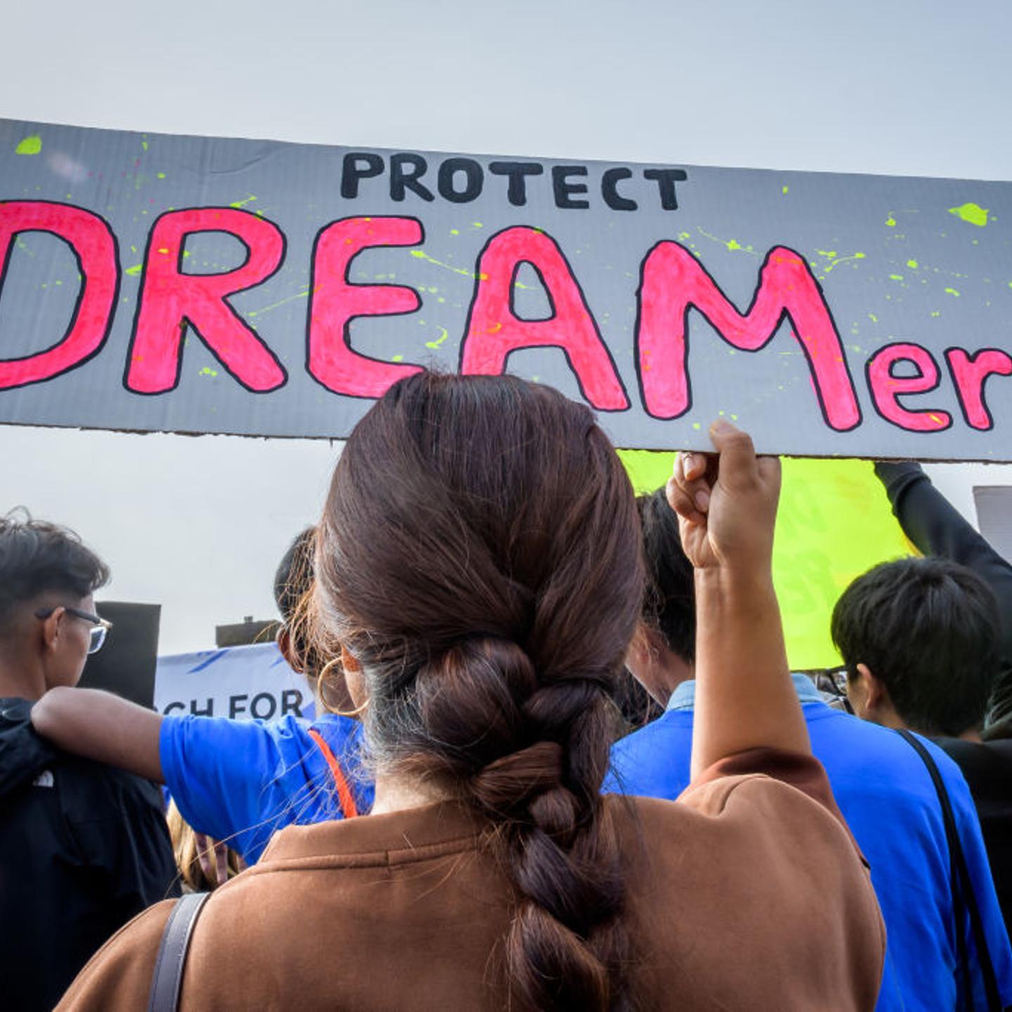 Participant holding a protest sign at the rally. Immigration
