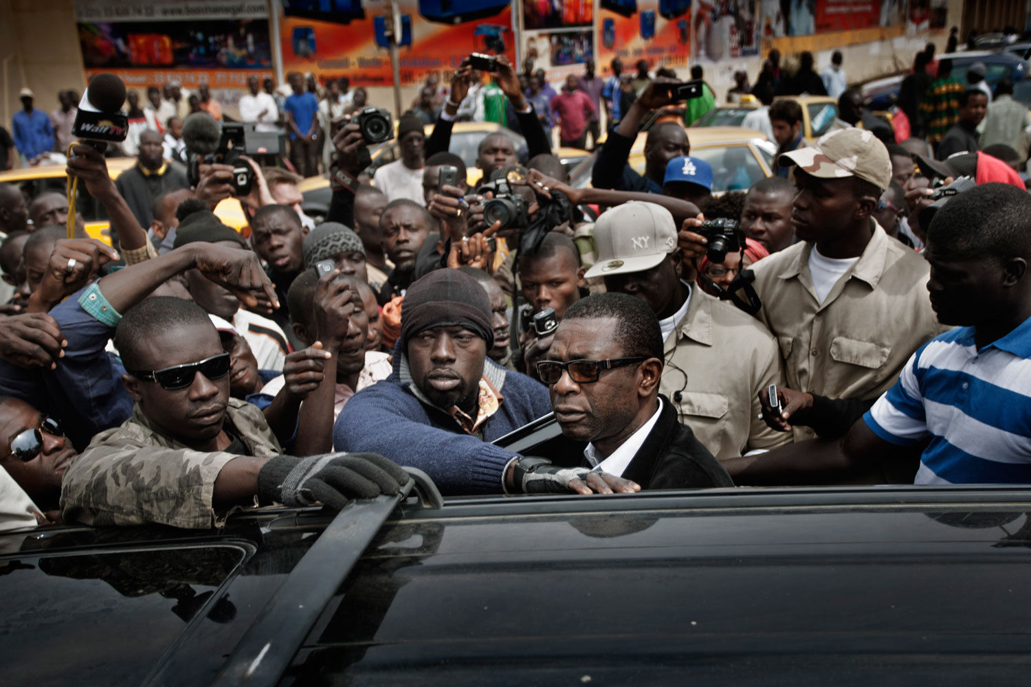 Dakar, Senegal, Feb. 15, 2012. Youssou N'Dour looks at the crowd forming around him in Independence Square after street clashes between protesters and police.