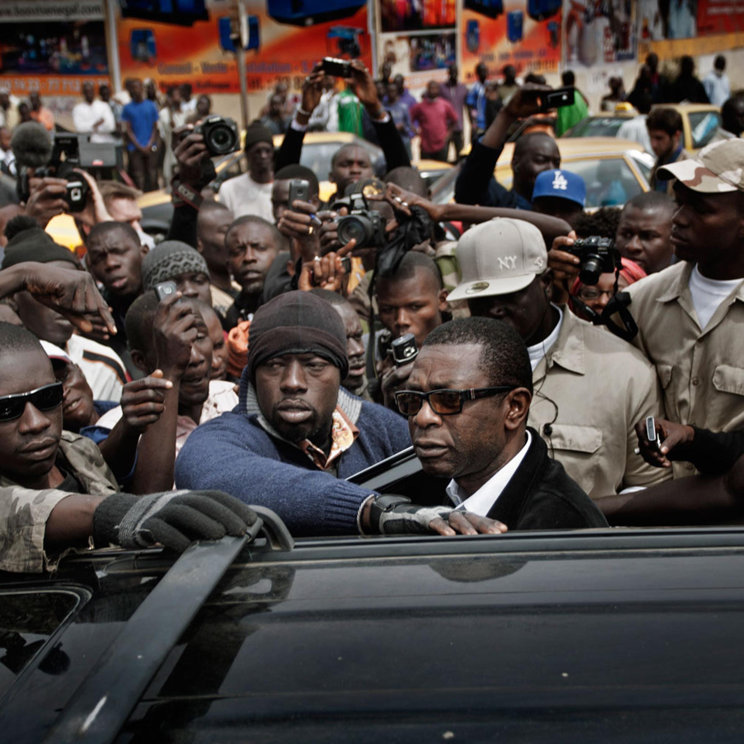Dakar, Senegal, Feb. 15, 2012. Youssou N'Dour looks at the crowd forming around him in Independence Square after street clashes between protesters and police.