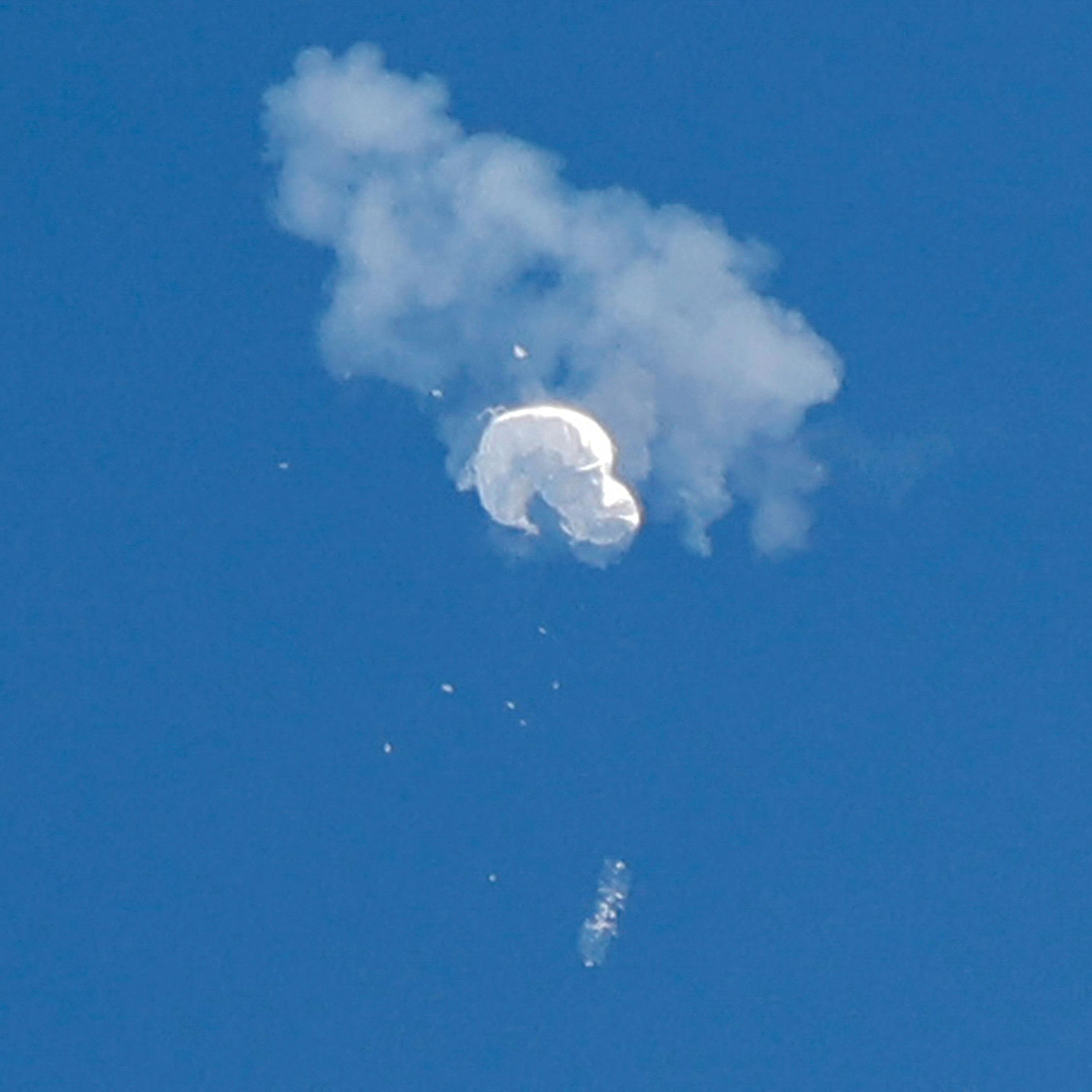 The suspected Chinese spy balloon drifts to the ocean after being shot down off the coast in Surfside Beach