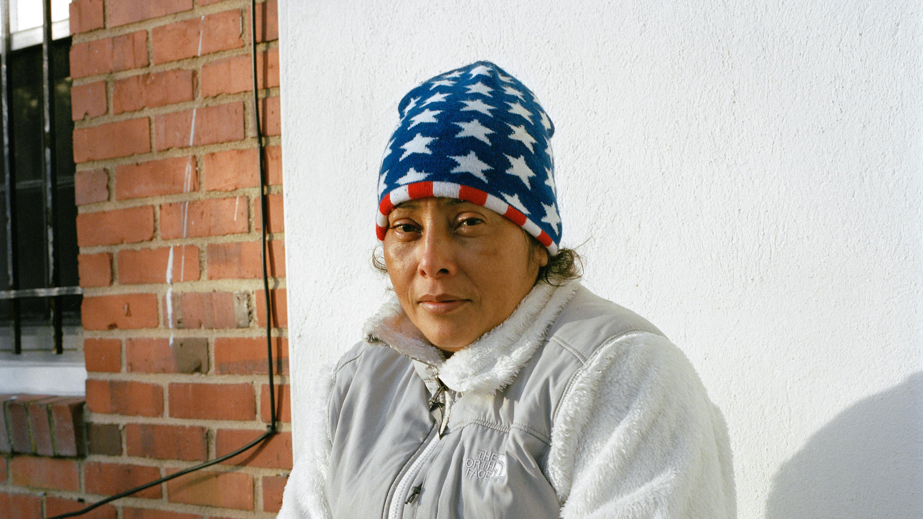 Maria Lidia Meza Castro, 40, sits in front of her new house on March 7. For the past four months, Castro and her children have been living in a house in the suburbs of Washington, D.C. while her attorneys gather all the documentation necessary for her as