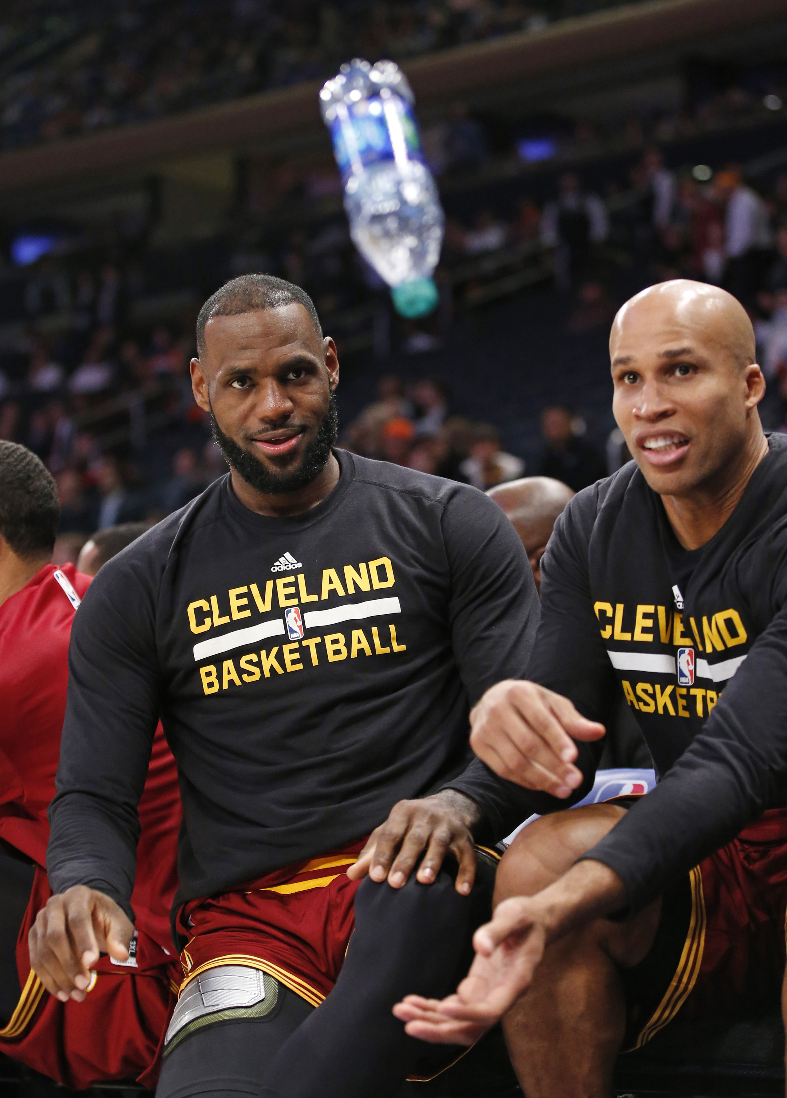Cleveland Cavaliers forward LeBron James, left, and Cavaliers forward Richard Jefferson entertain themselves by flipping a water bottle trying to get it to land on it's flat bottom during the fourth quarter of an NBA basketball game against the New York 