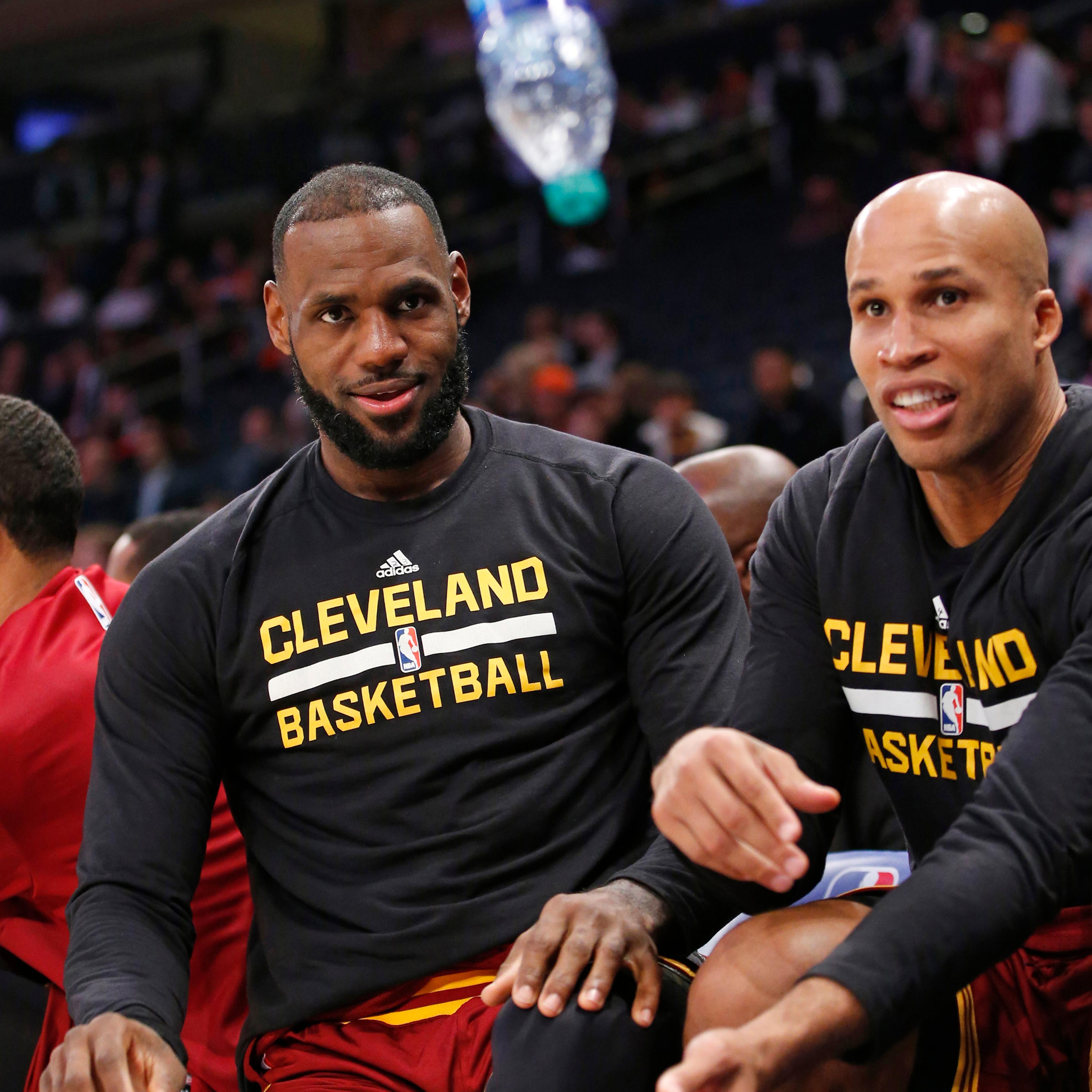 Cleveland Cavaliers forward LeBron James, left, and Cavaliers forward Richard Jefferson entertain themselves by flipping a water bottle trying to get it to land on it's flat bottom during the fourth quarter of an NBA basketball game against the New York