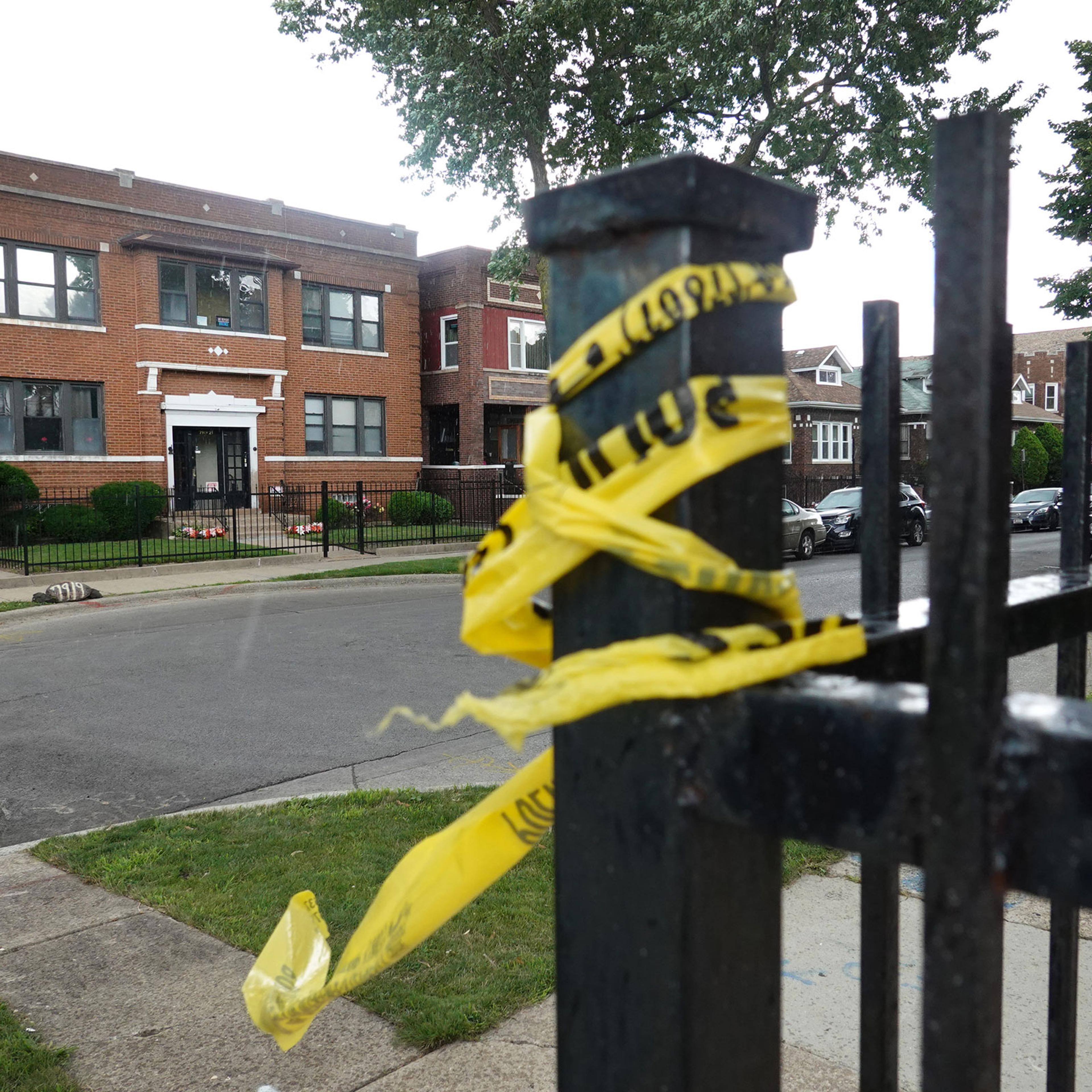 Crime scene tape remains on a fence near the Rhodes funeral home in the Auburn Gresham neighborhood, where at least 15 people were shot during a funeral, in Chicago on July 22, 2020.