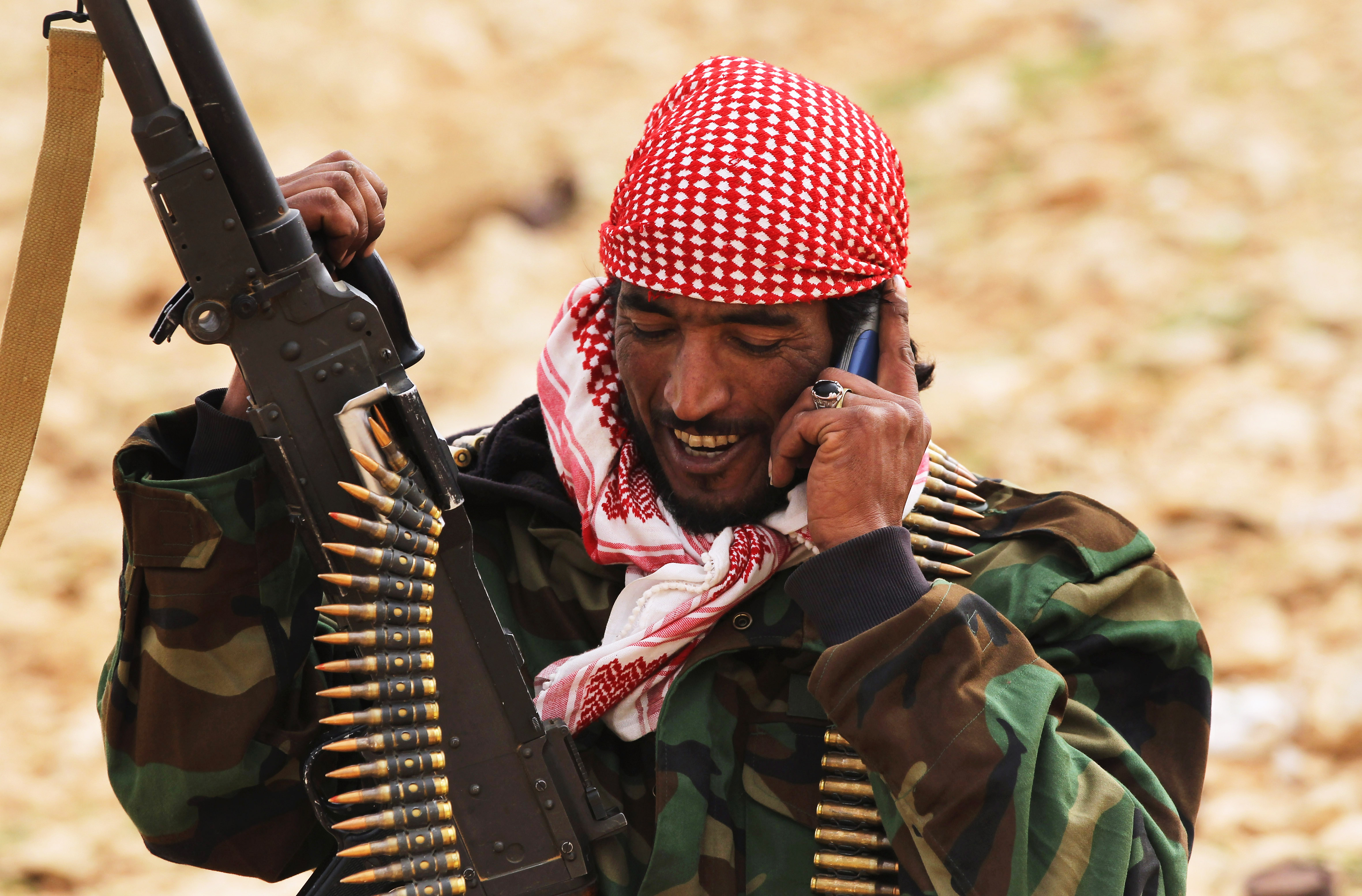 A rebel militiaman speaks on his mobile phone after capturing territory from government troops on March 25 2 in Ben Jawat, Libya.
