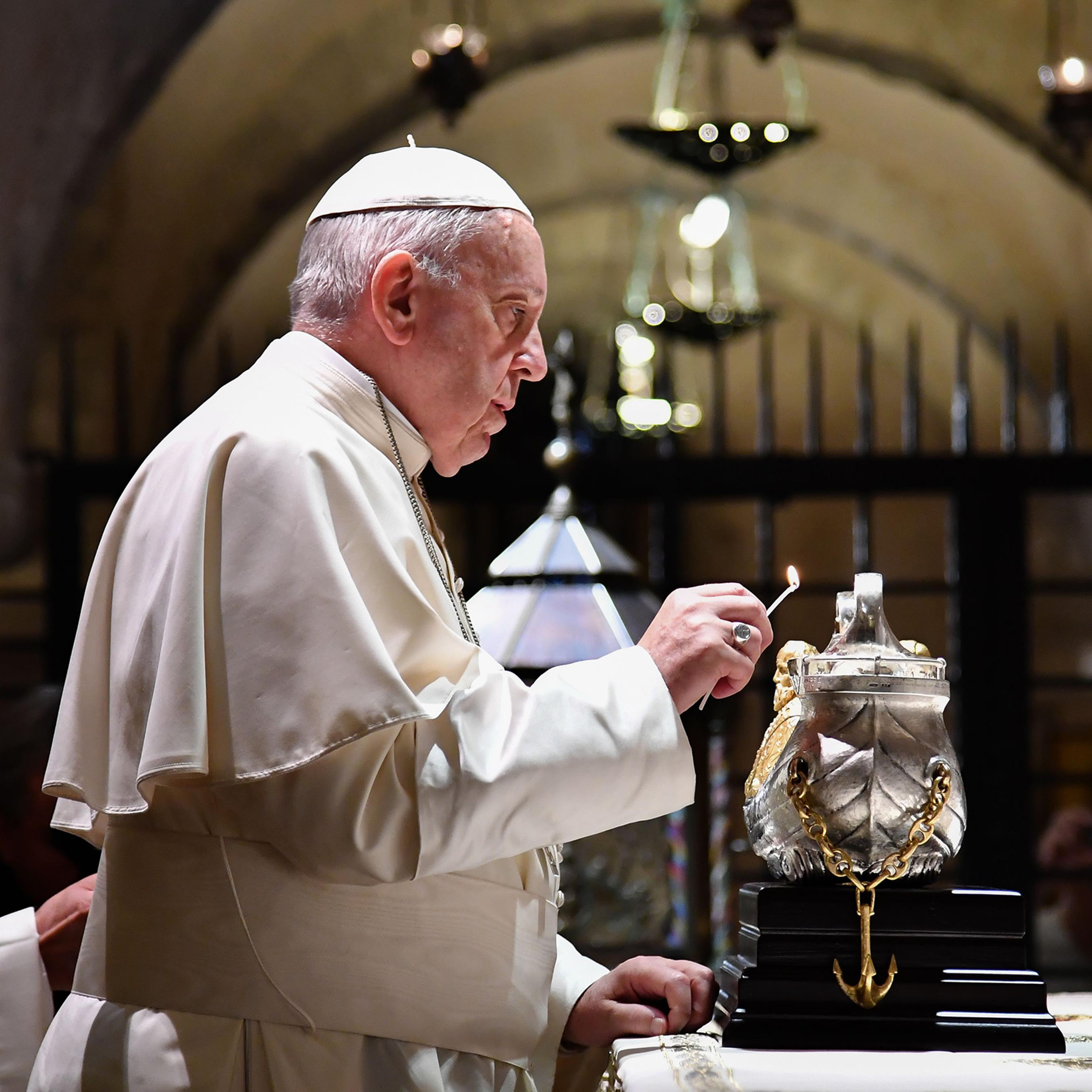 Pope Francis lights the uniflamma lamp at the tomb of Saint Nicholas in Pontifical Basilica of St Nicholas in Bari, Italy, on July 7, 2018.