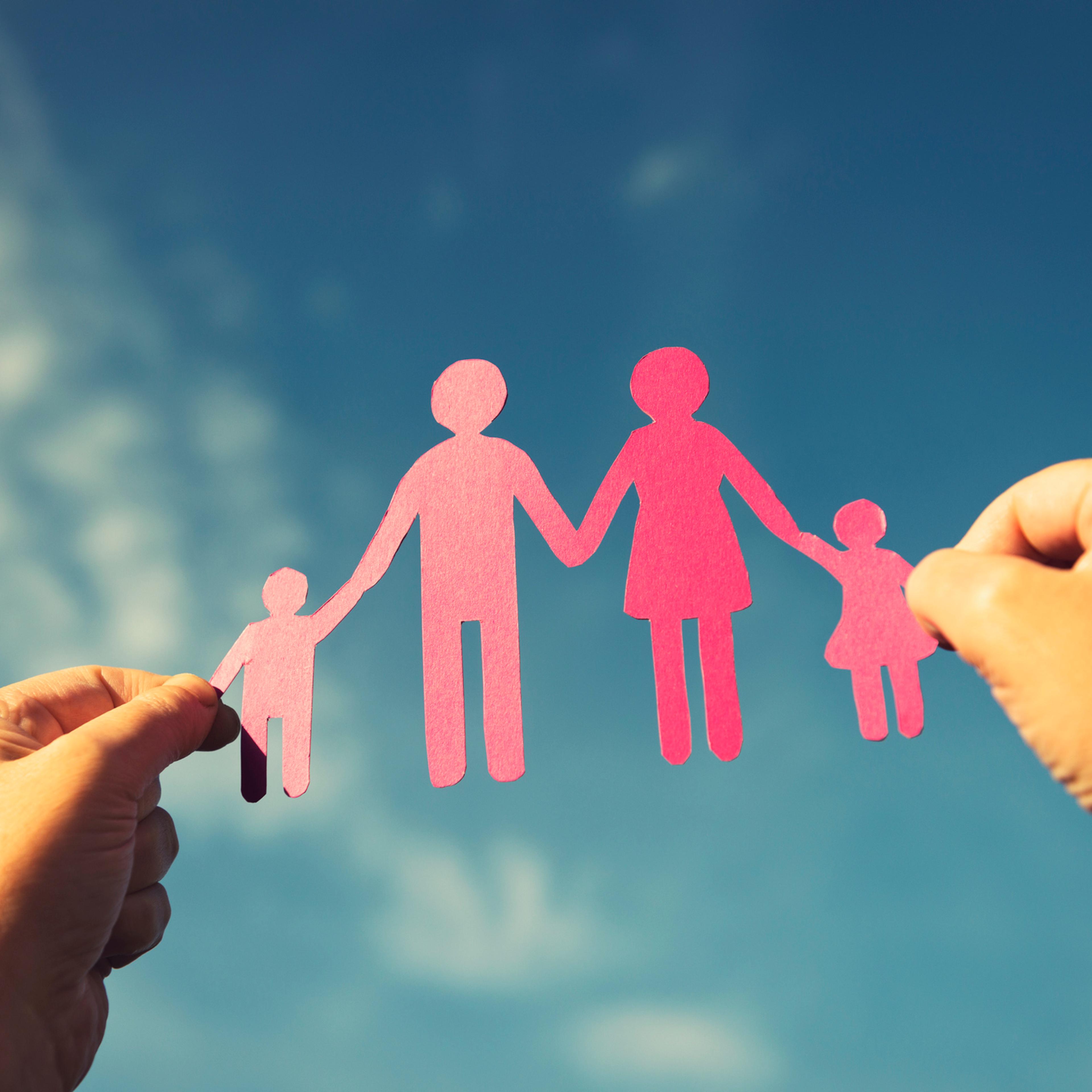 Family paper dolls against the sky
