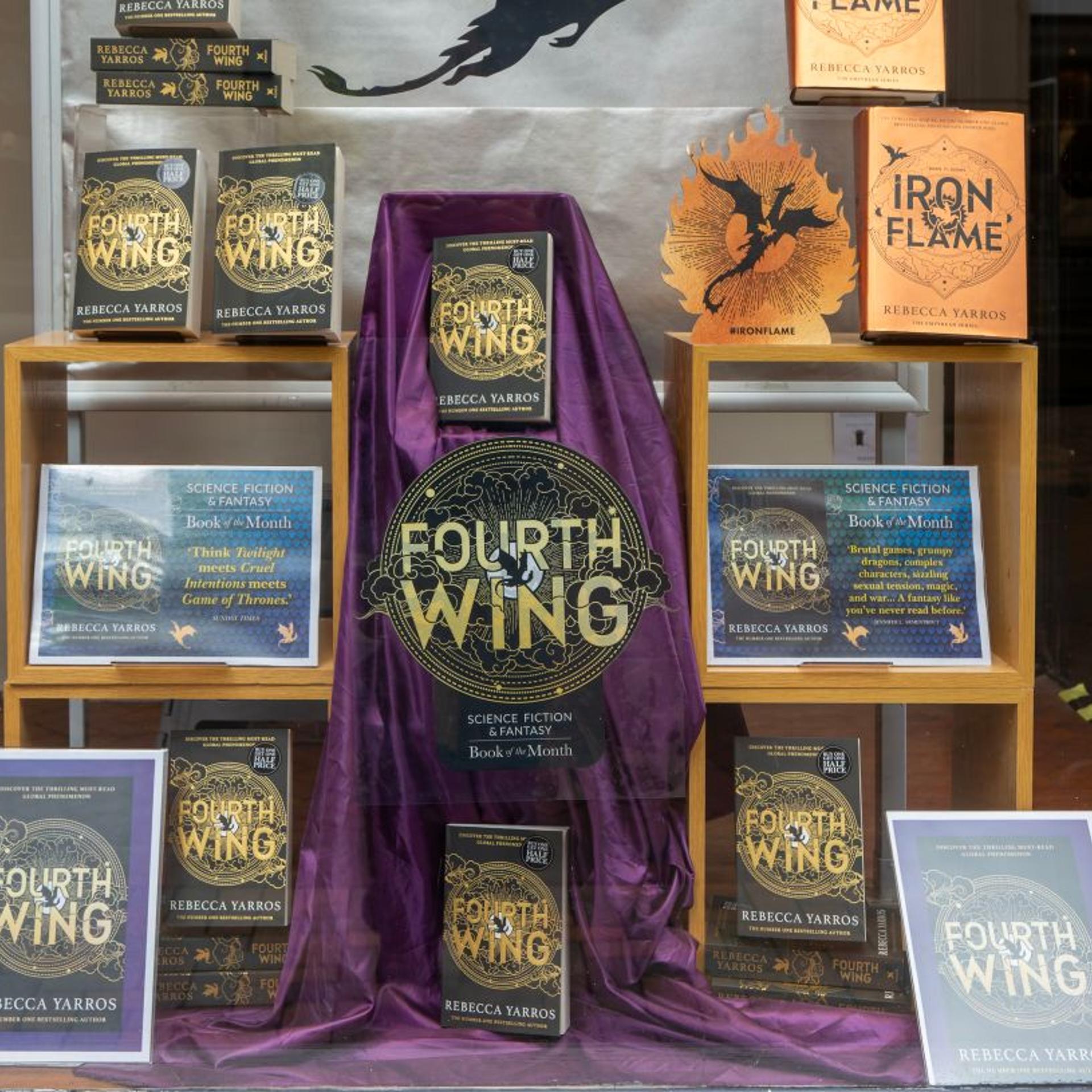 Book display 'Fourth Wing' by Rebecca Yarros in shop window of Waterstones bookshop, Ipswich, Suffolk, England, UK