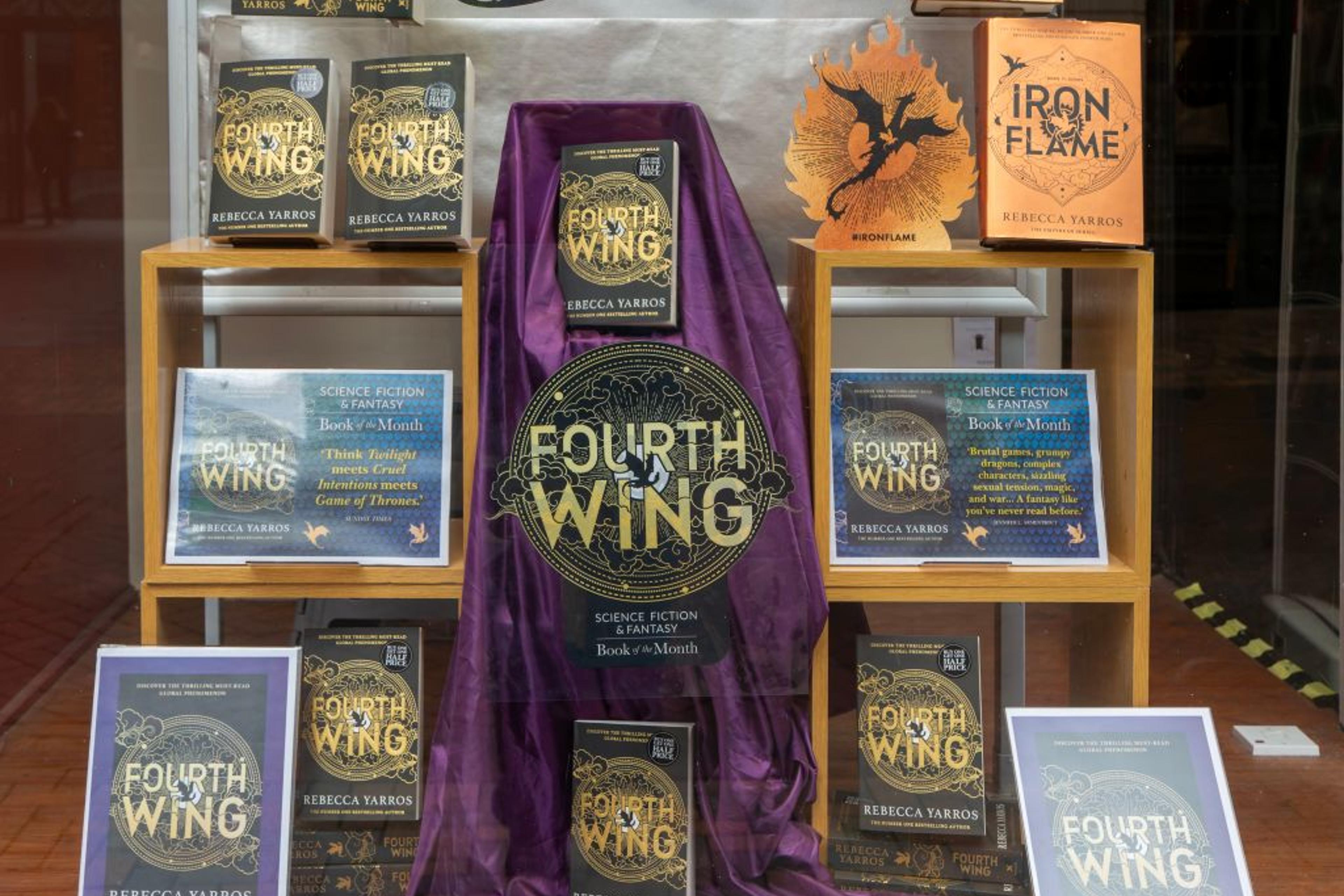 Book display 'Fourth Wing' by Rebecca Yarros in shop window of Waterstones bookshop, Ipswich, Suffolk, England, UK