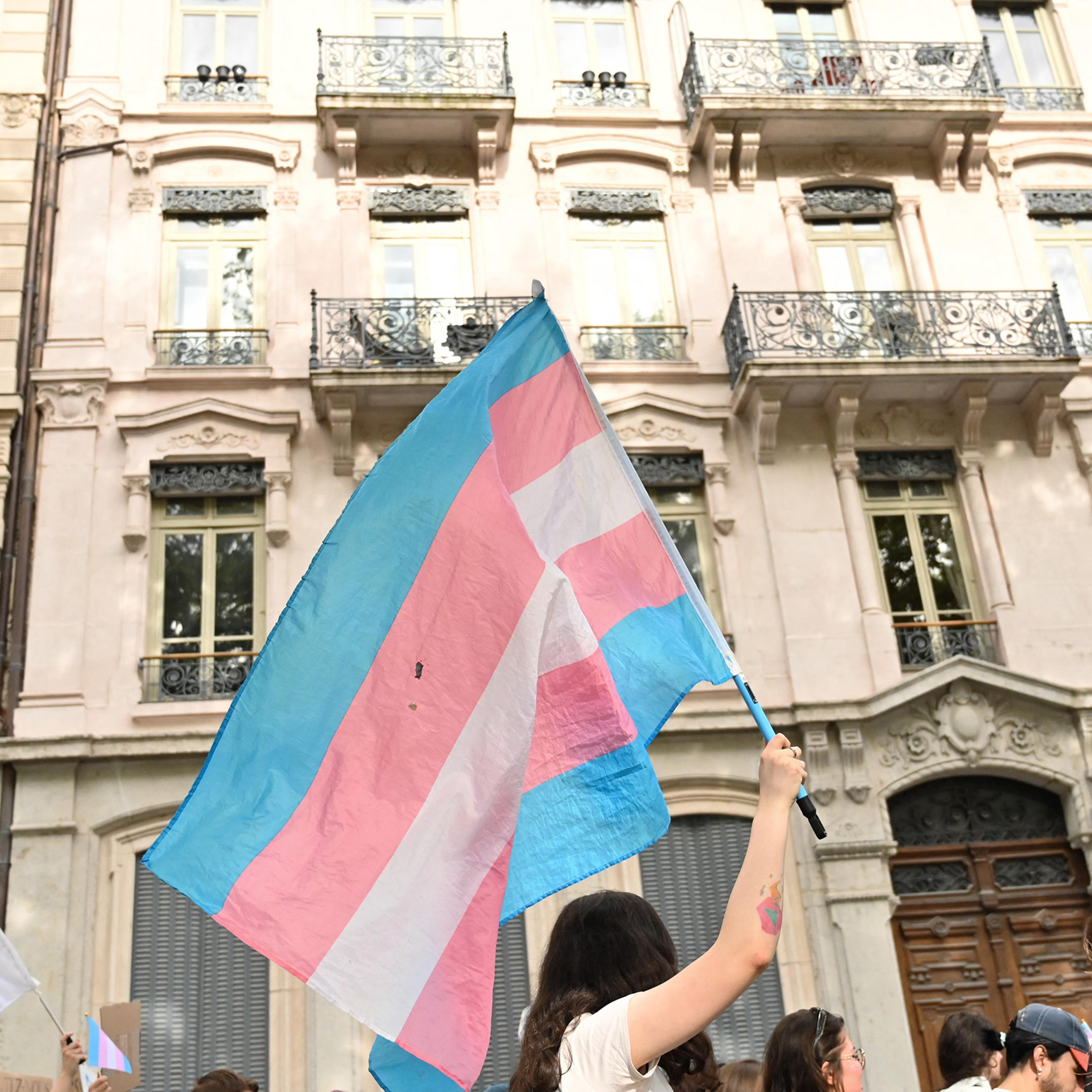A trans pride flag flies during a demonstration for trans rights in Lyon, France on May 25, 2024.