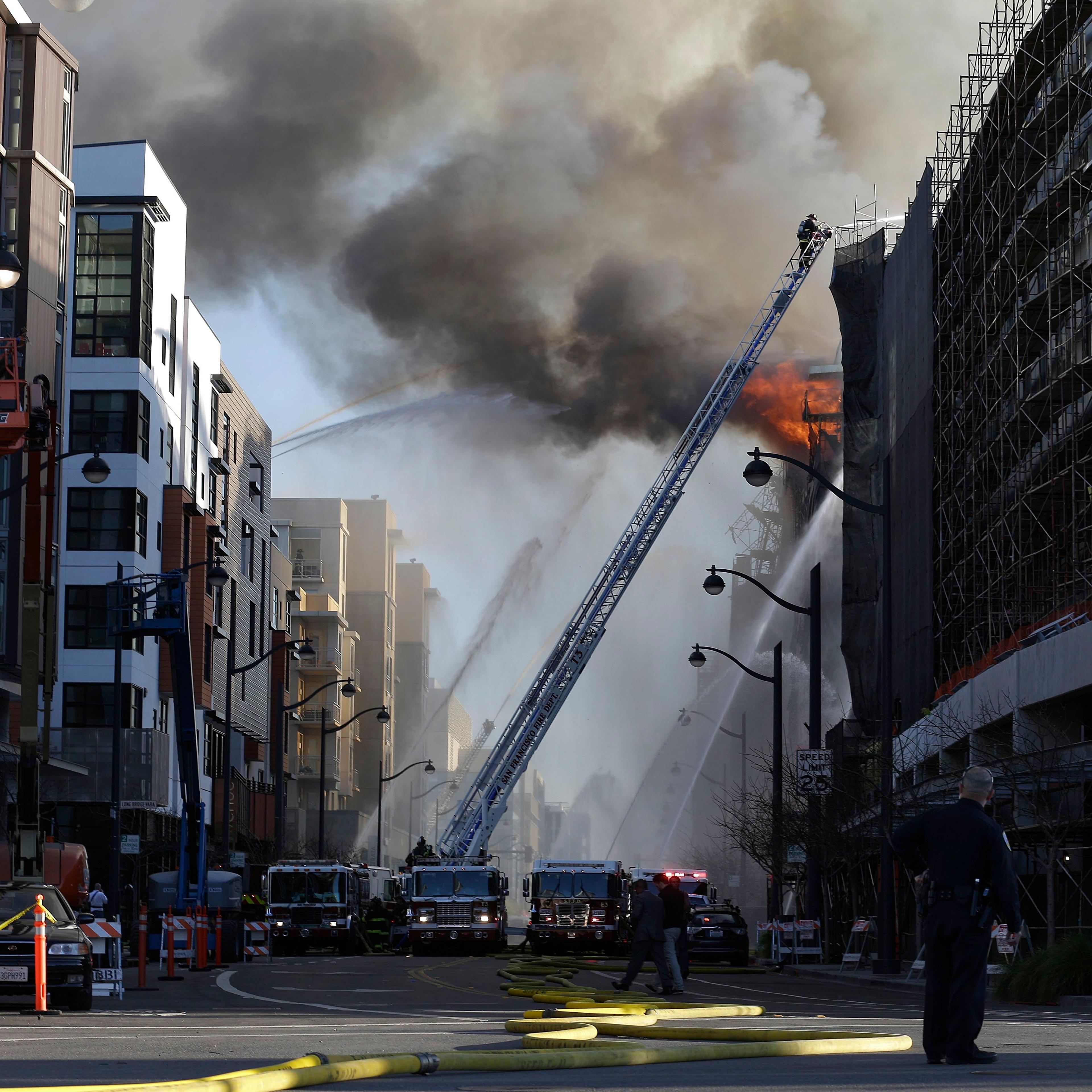 Firefighters battle a fire burning in San Francisco
